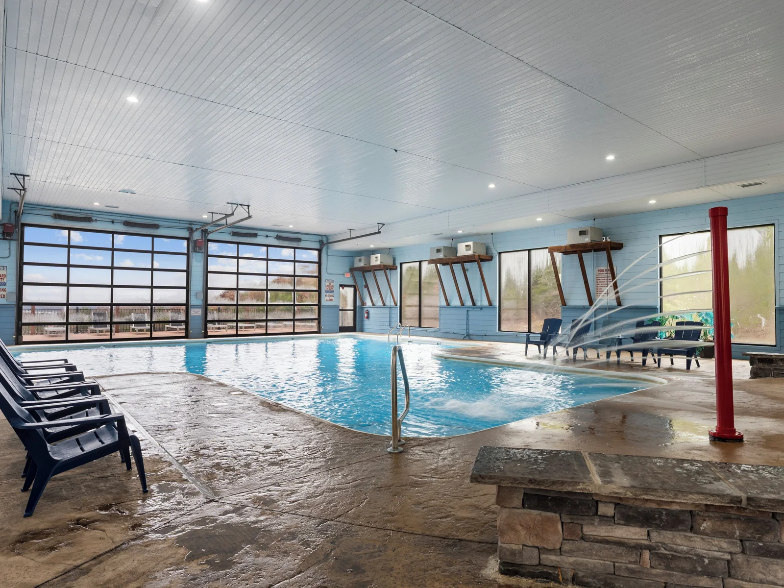 Indoor pool. Heated, and fun kid friendly features. Bathrooms, lounge chairs, and dining tables. Open year round.