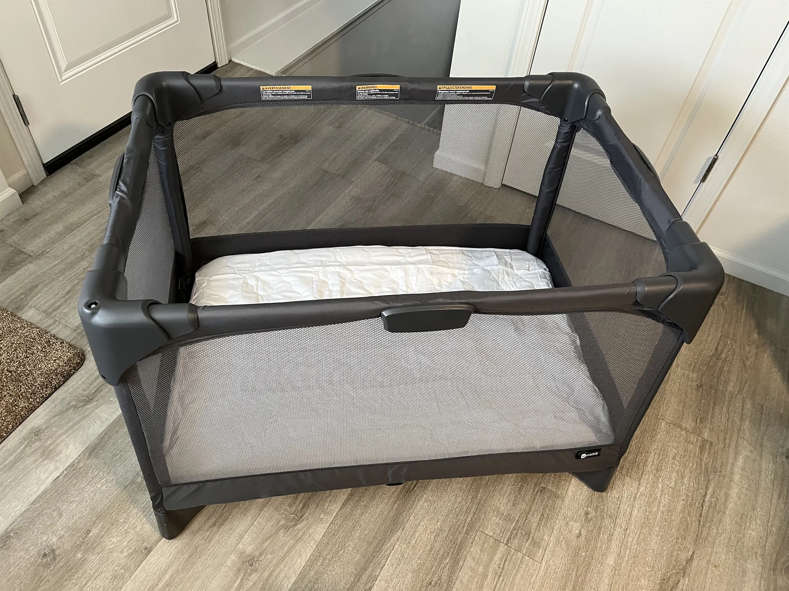 Portable play and mattress cover provided. Located in main floor closet in black carry case.