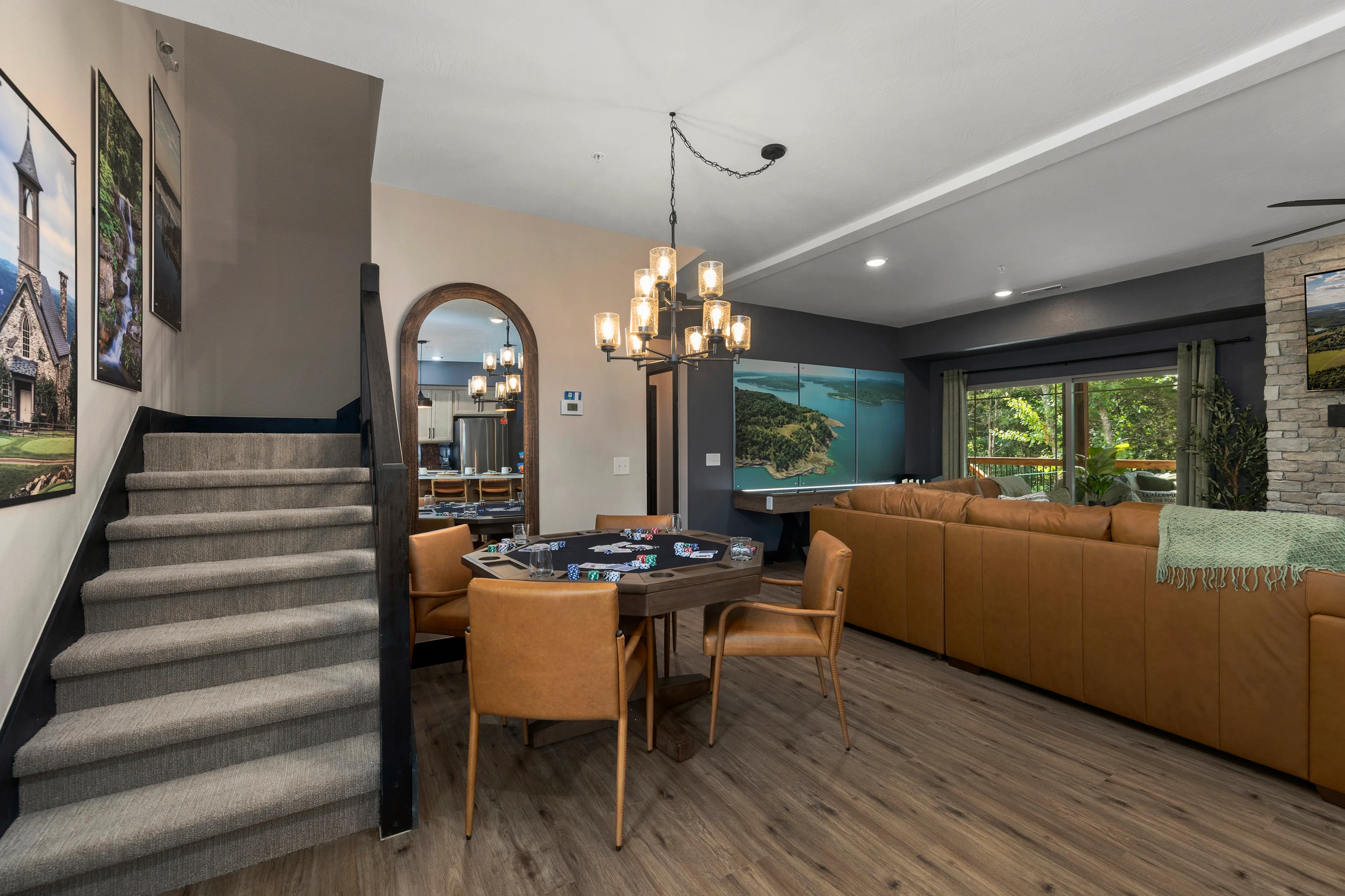 Chandelier-lit dining flows past the staircase into the living room beyond.