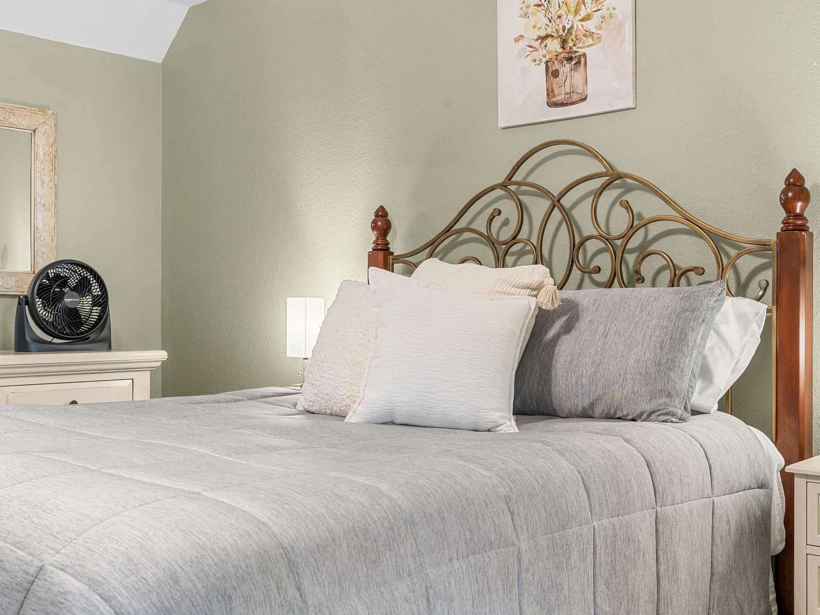 Ornate gold headboard, warm amber light, and green walls — the upstairs bedroom has a boutique hotel feel that guests keep mentioning in reviews.