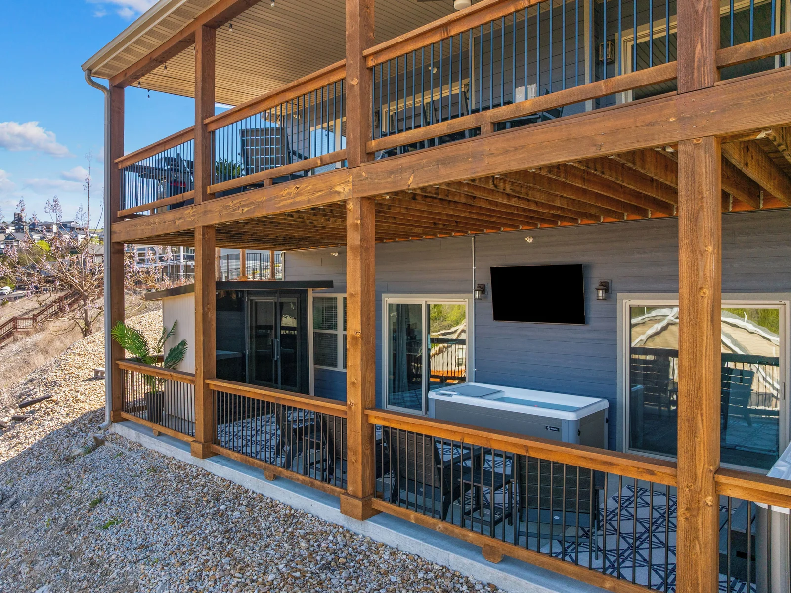 Upper deck for gathering; lower wellness porch for revitalizing.
