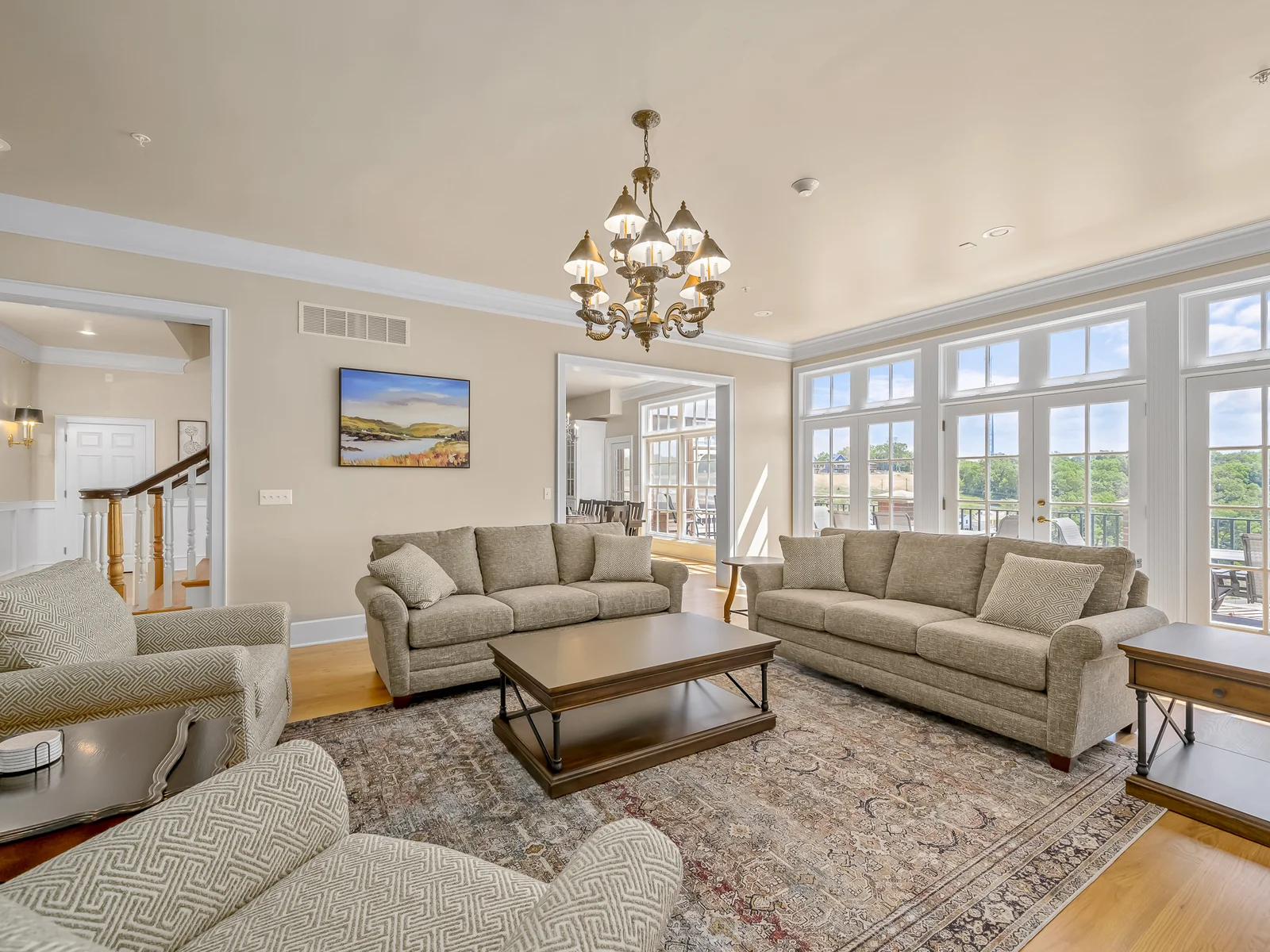 Views off of the living room overlooking the lake. Sofa table near french doors serves as additional dining seating.