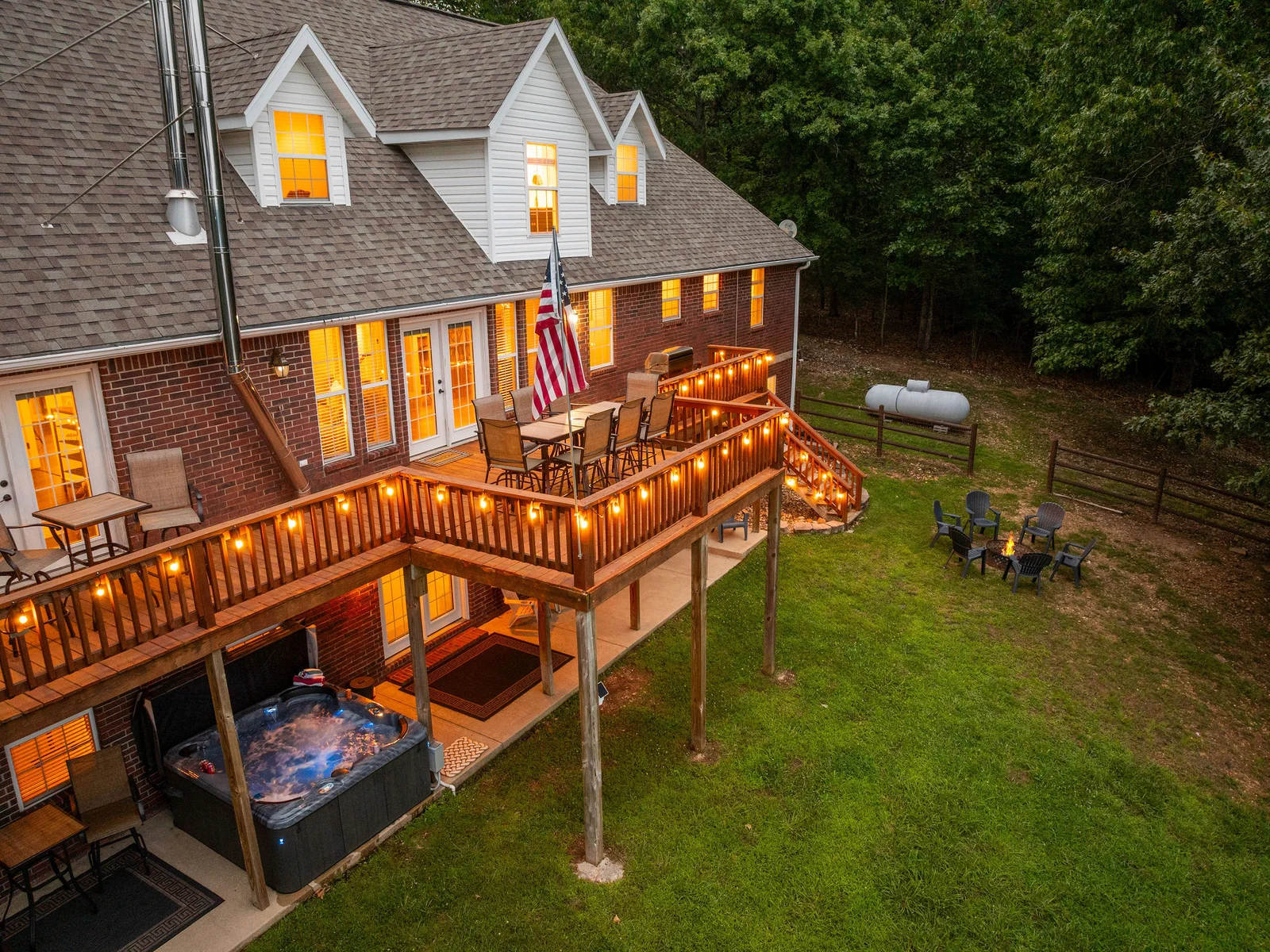 String lights overhead, drinks on the table, lake glimmering below — the upper deck dining area at twilight is where the best nights start.
