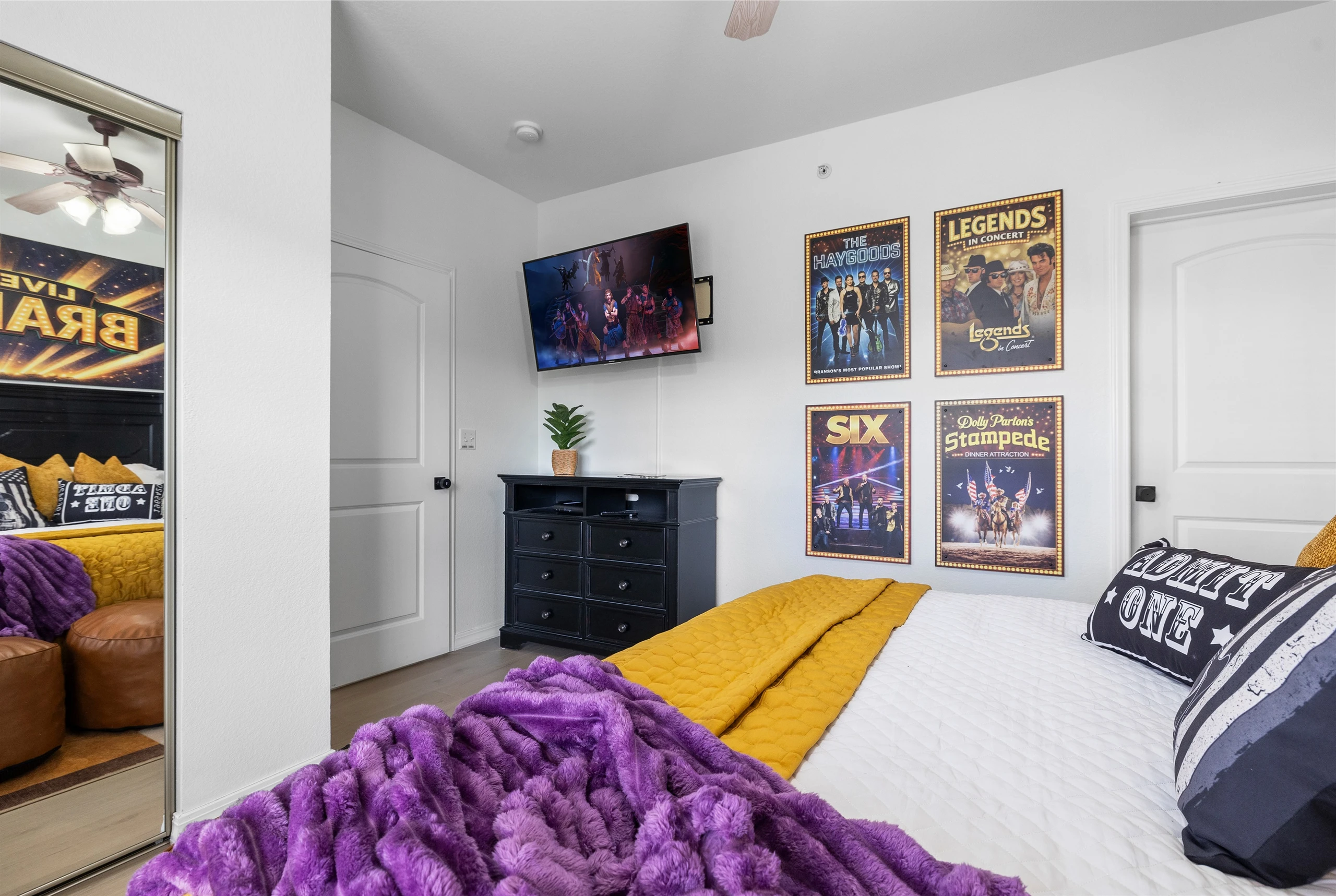 The Music room has a large smart TV, custom artwork a dresser and attached ensuite bathroom