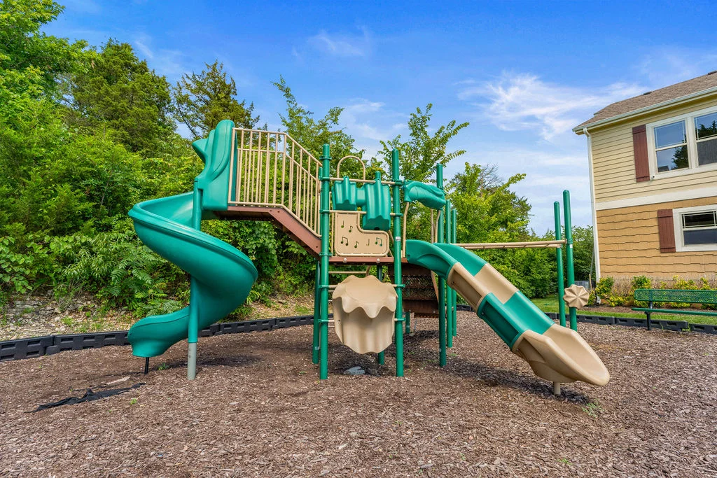 The playground is next to the Clubhouse and pool.