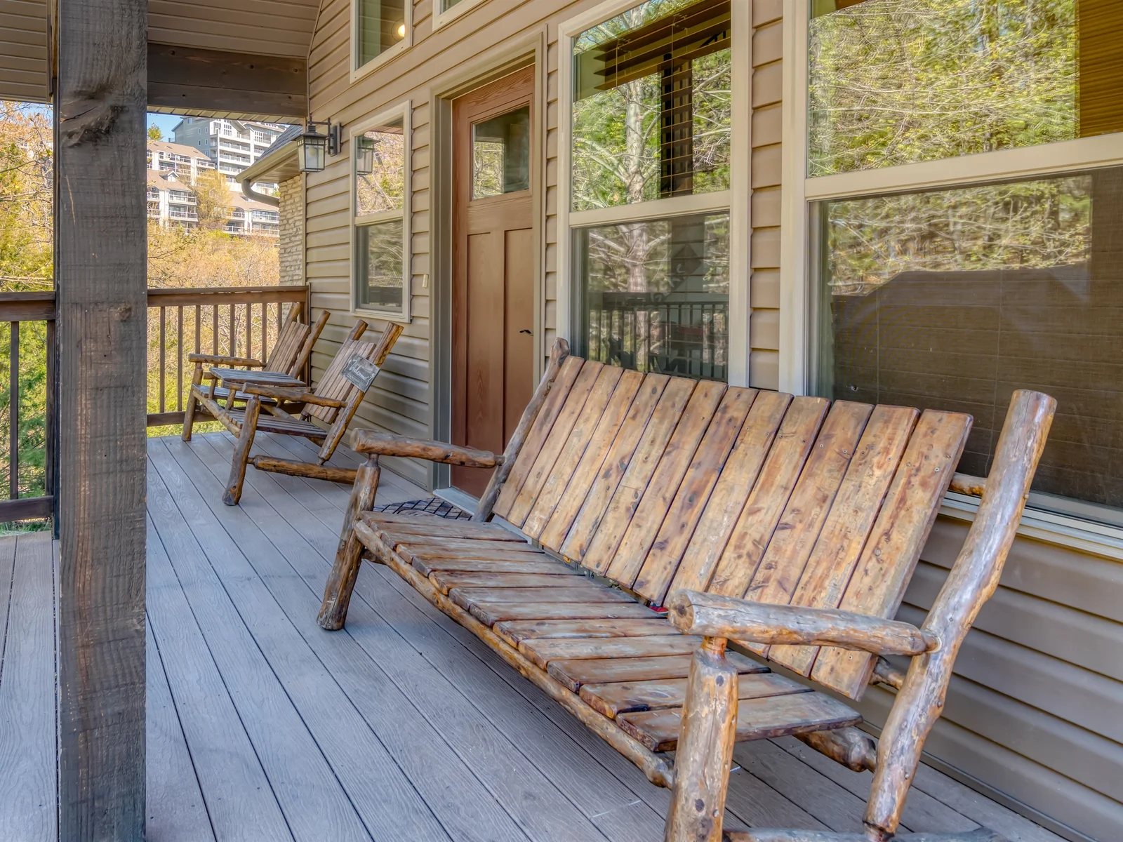 Front porch entry with rustic wood furniture