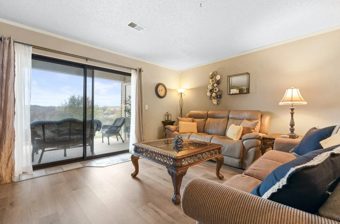 Living area with comfy seating and sliding doors to the patio.