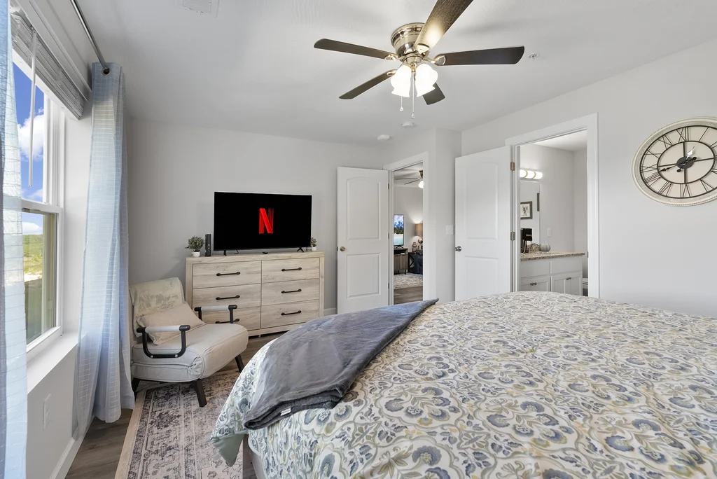 Primary King room complete with dresser, 55" smart TV and seating