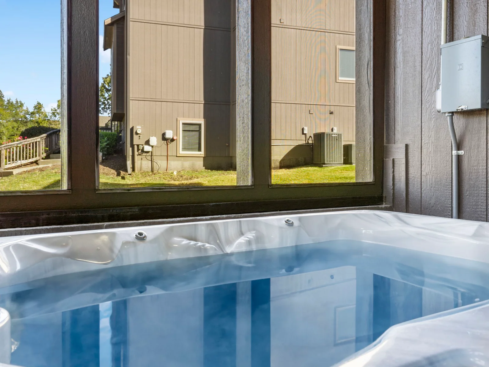 Hot tub on lower level with screened porch
