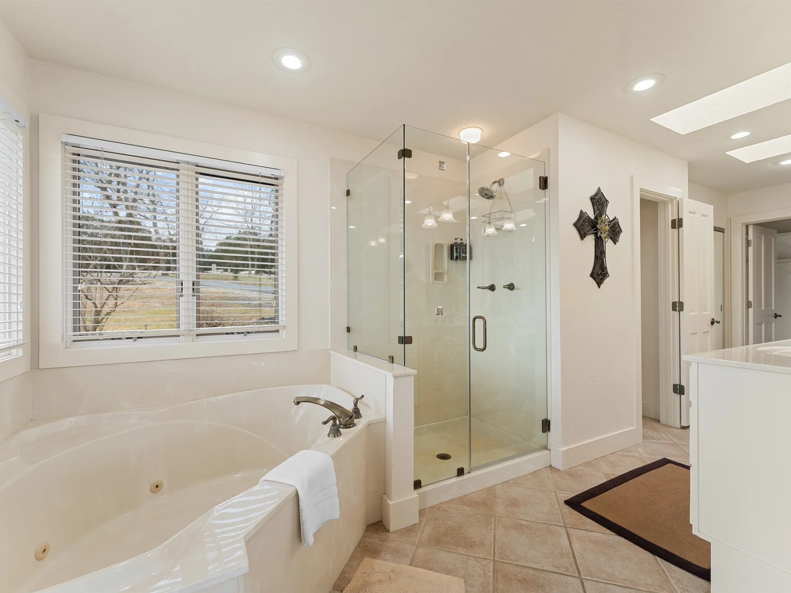 Unwind in a spacious bath with a soaking tub and walk-in shower, perfect for easing into vacation mode.