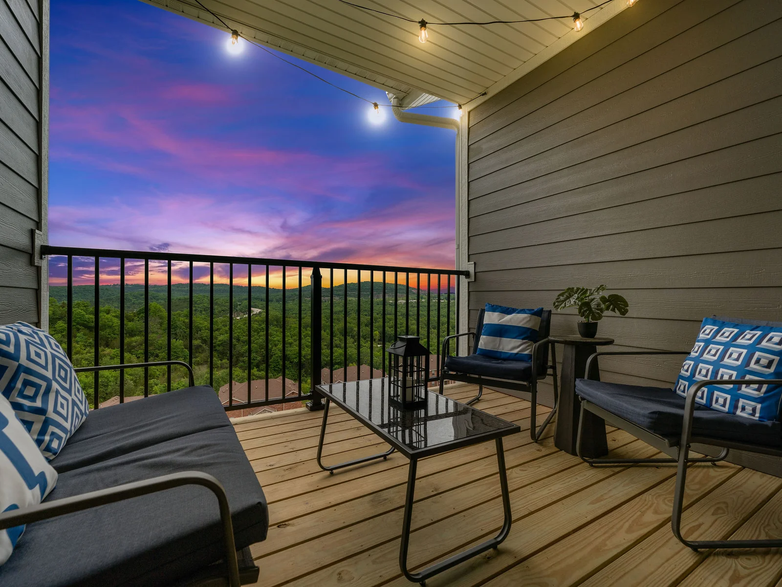 Step outside while the household is quiet — string lights glowing above you, the Ozark mountain panorama stretching out in every direction. This is the moment you'll text home about.