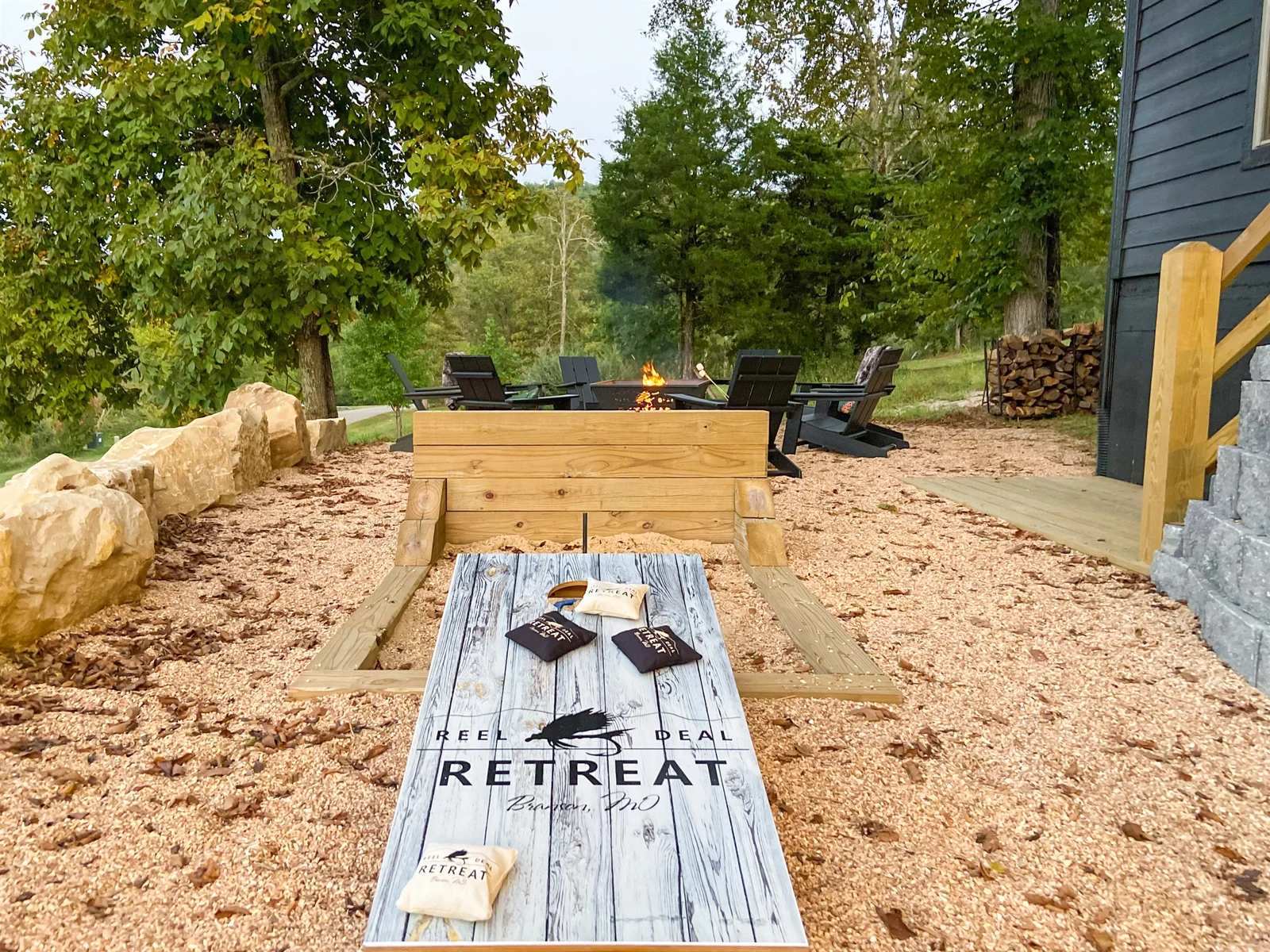 Corn hole, horseshoes, and firepit in the backyard