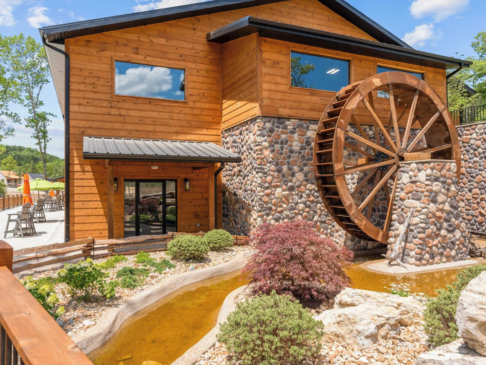 Indoor pool with active water wheel, can be seen from back deck of the cabin.