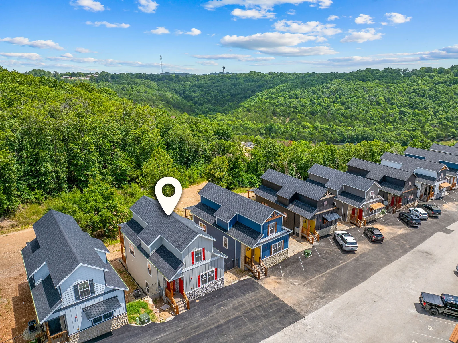 Take in the beauty of the community from above, surrounded by charming homes and peaceful Ozark scenery. ✨