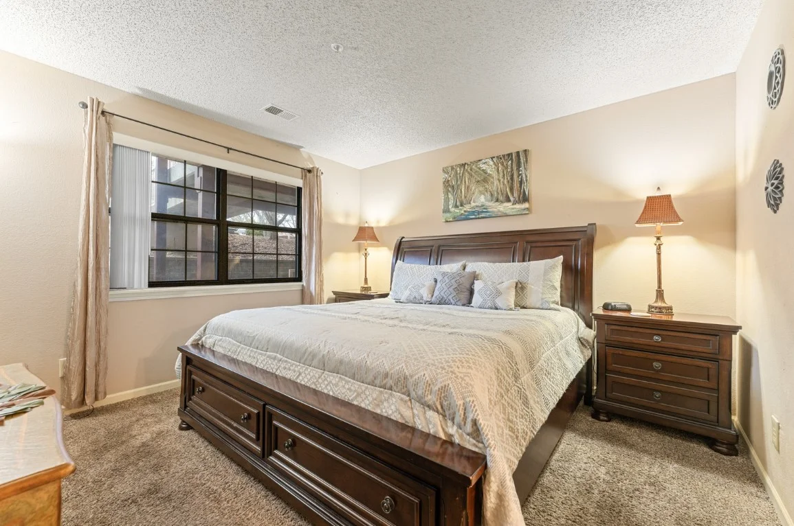 Guest bedroom at Wildwood Run with king bed and cozy lighting.