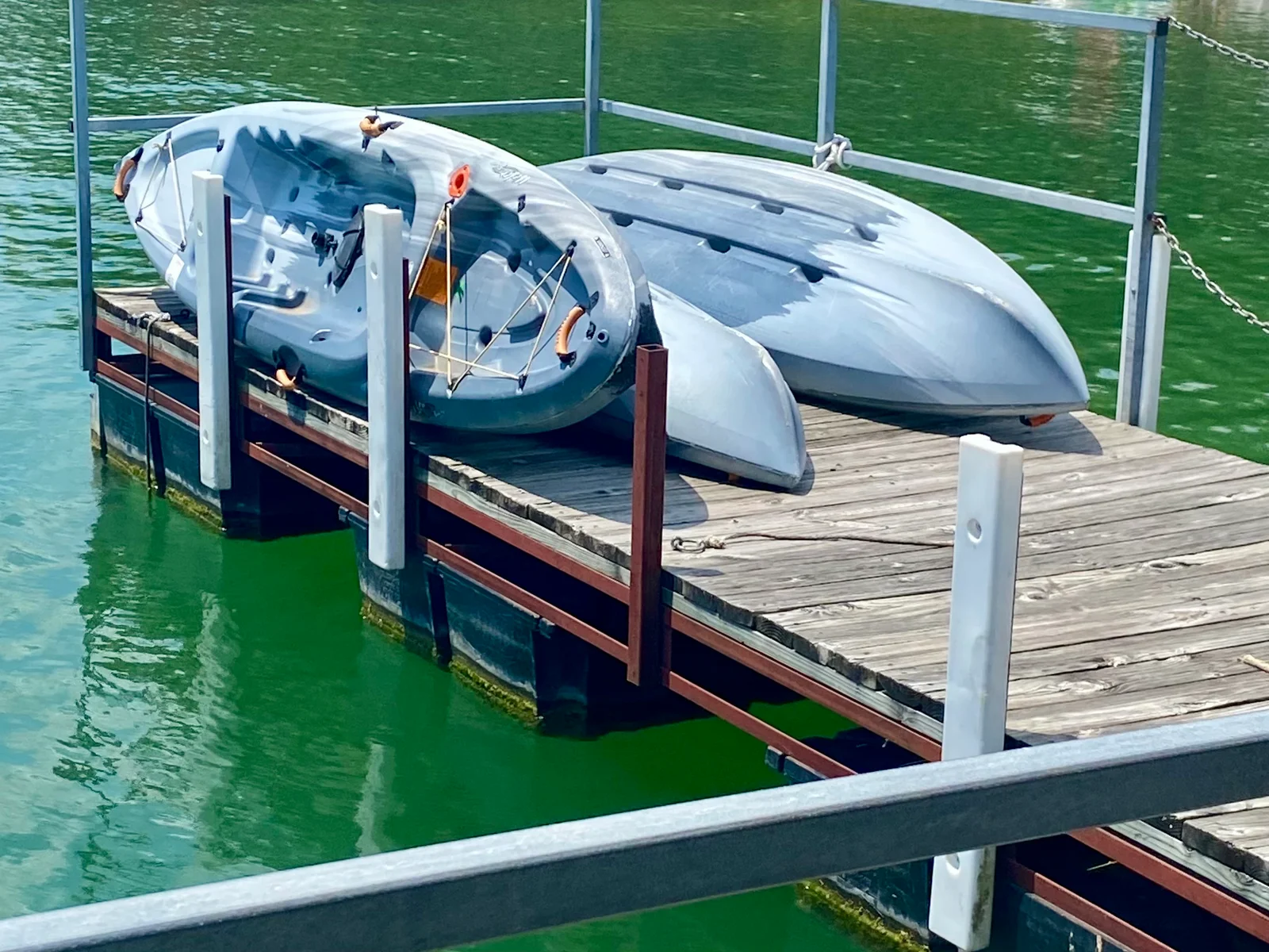 Kayaks and paddle boats available for checkout at the dock