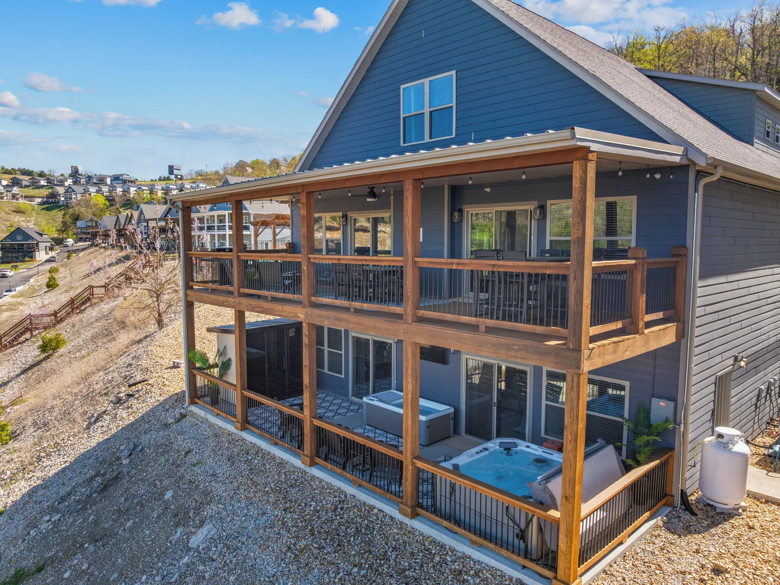 Upper deck for gathering; lower wellness porch for revitalizing.
