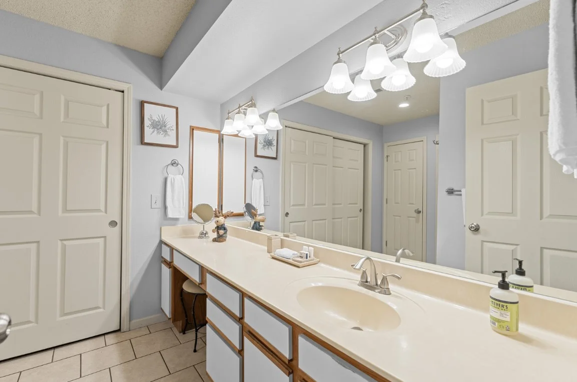 Clean, spacious bathroom with double vanity and bright lighting.