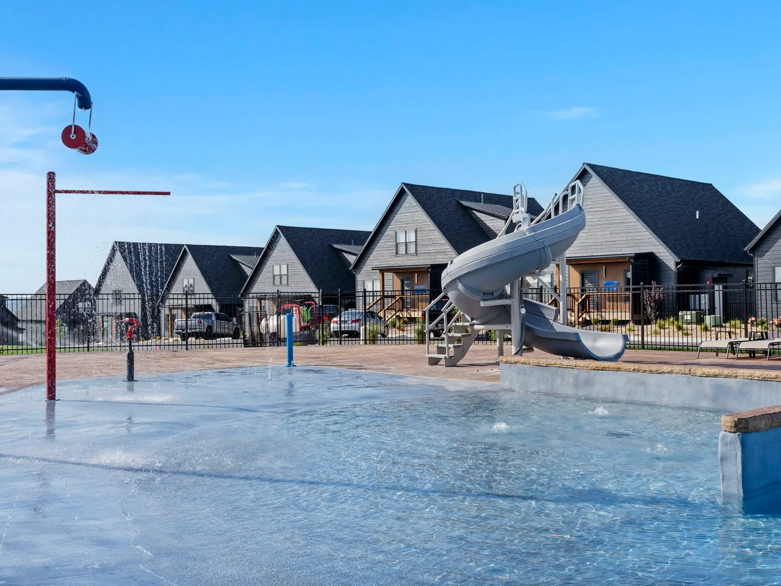 Outdoor community pool w/ slide and splash pad!