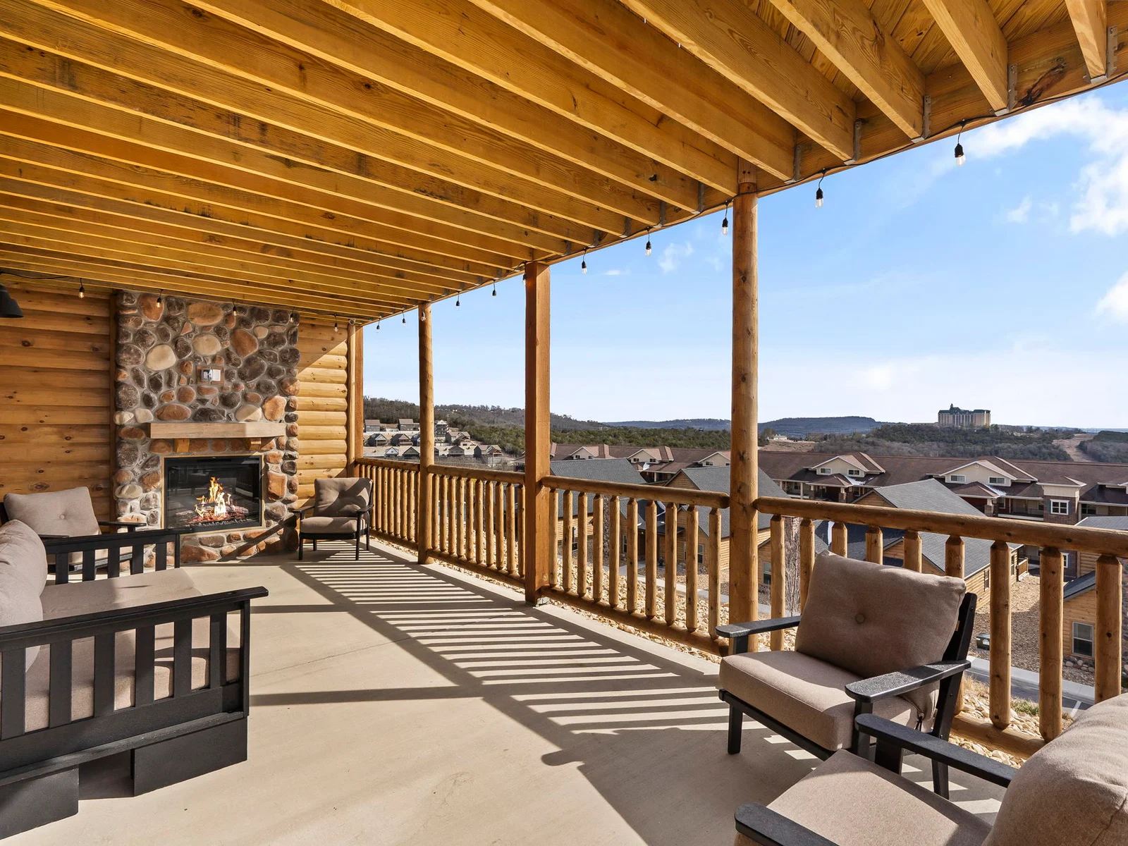 Entry level back patio with electric fireplace and cozy seating