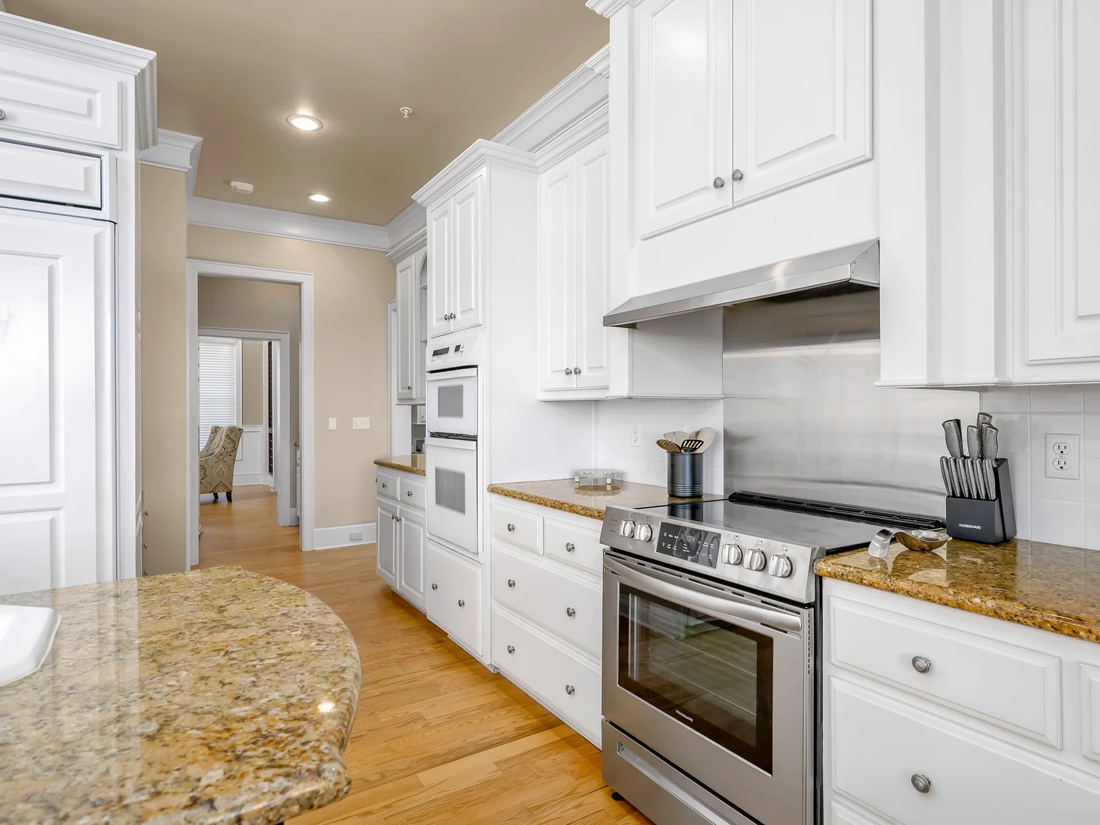 Kitchen leads to butler’s pantry connecting to wine room