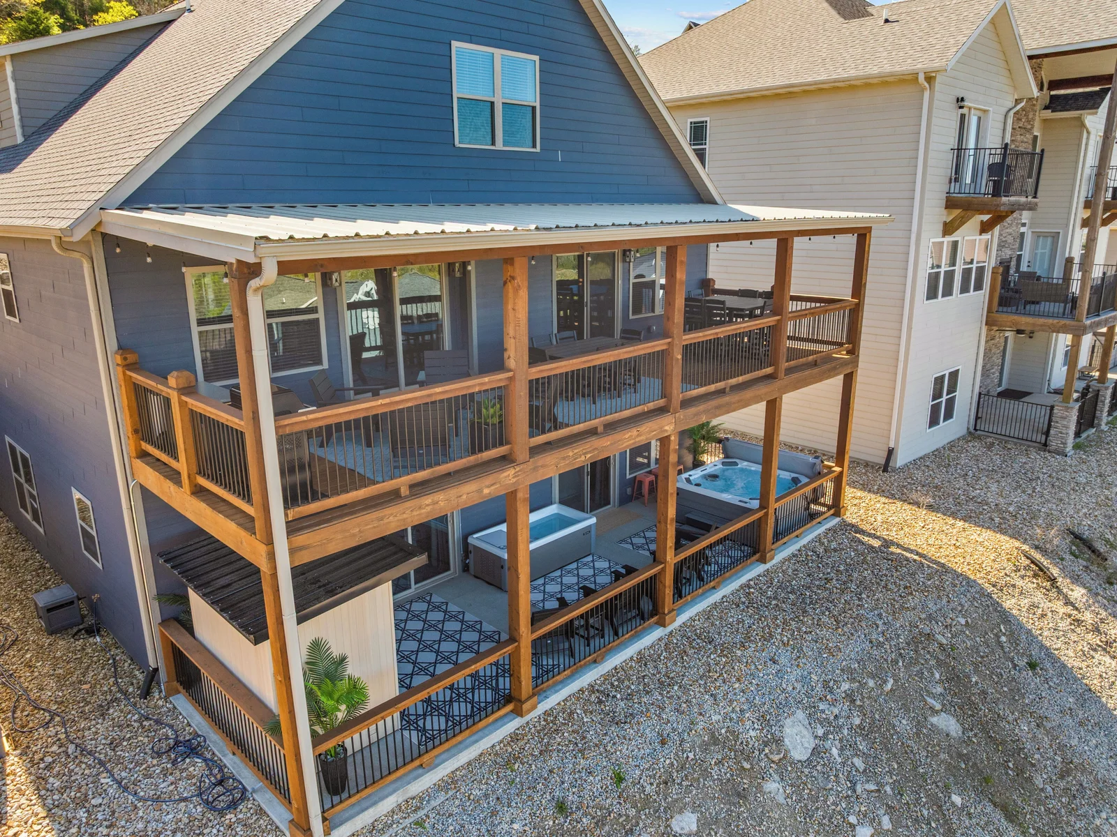 Upper deck for gathering; lower wellness porch for revitalizing.