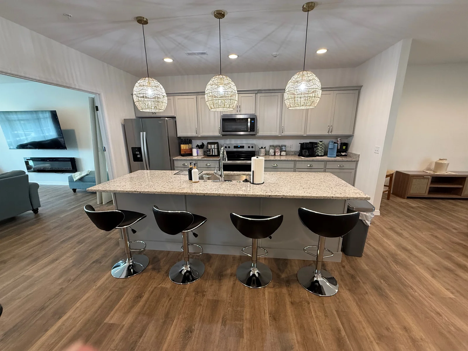 Open gourmet kitchen with stools at 6’ long island