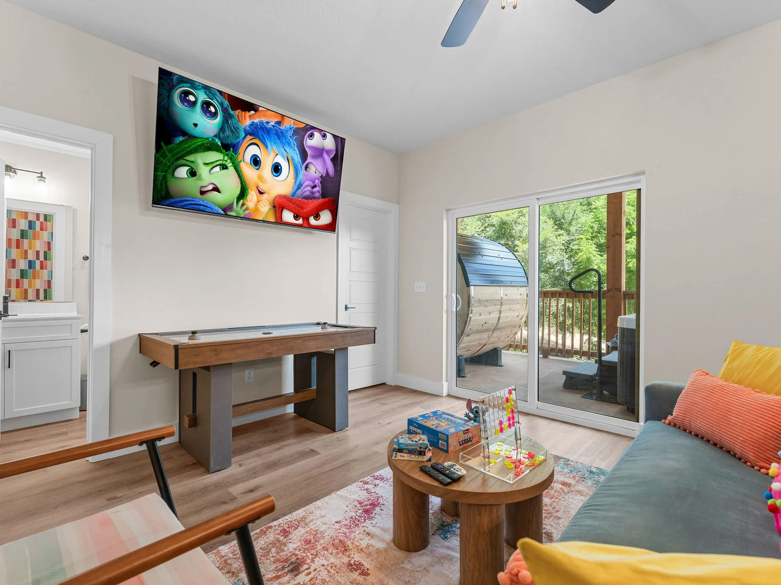 A colorful game room where you can play, relax, and enjoy movie nights together. 🎮🍿