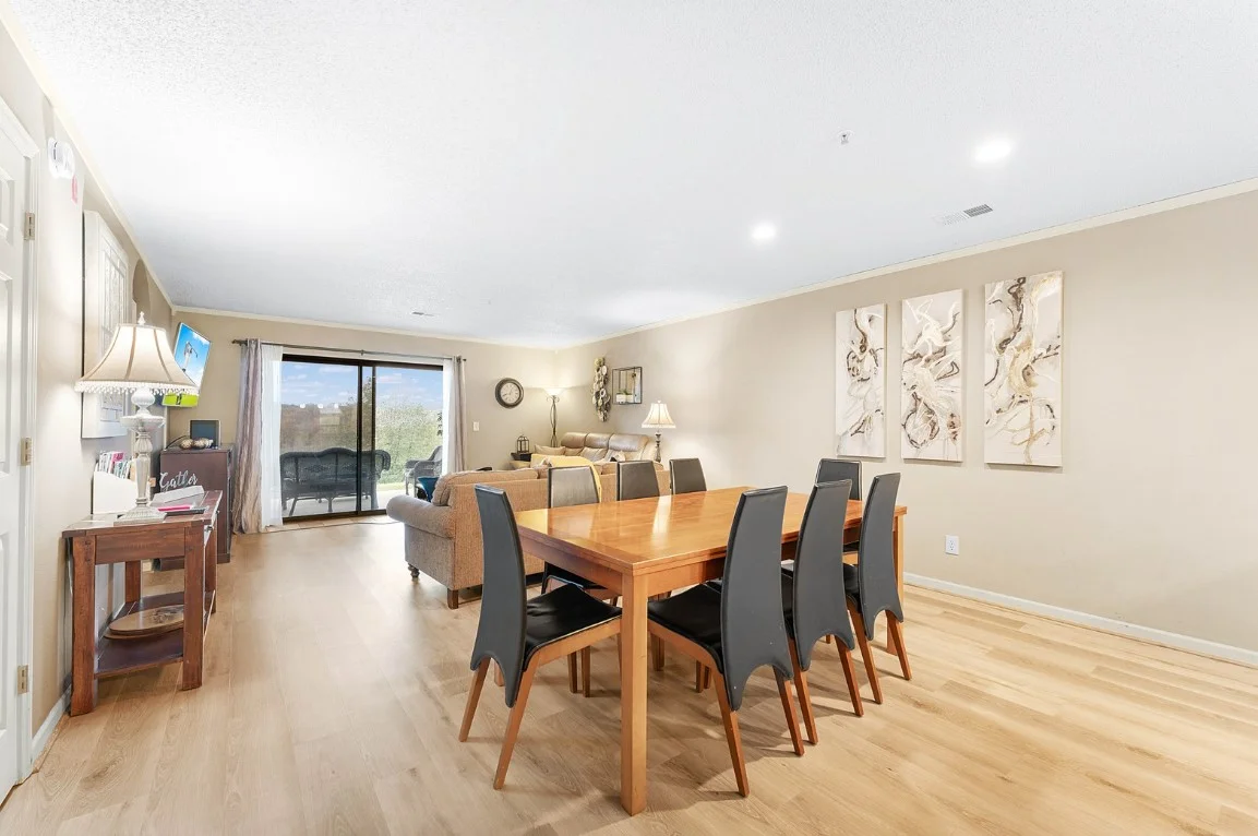 Dining area opens to the living room with balcony access and views.
