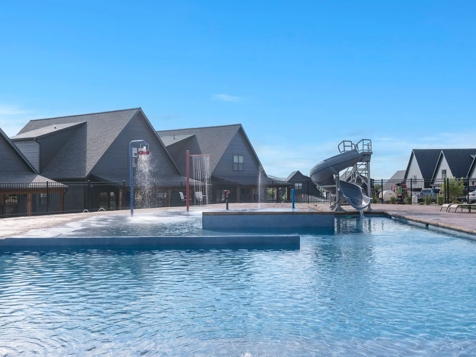 Large outdoor community pool with slide