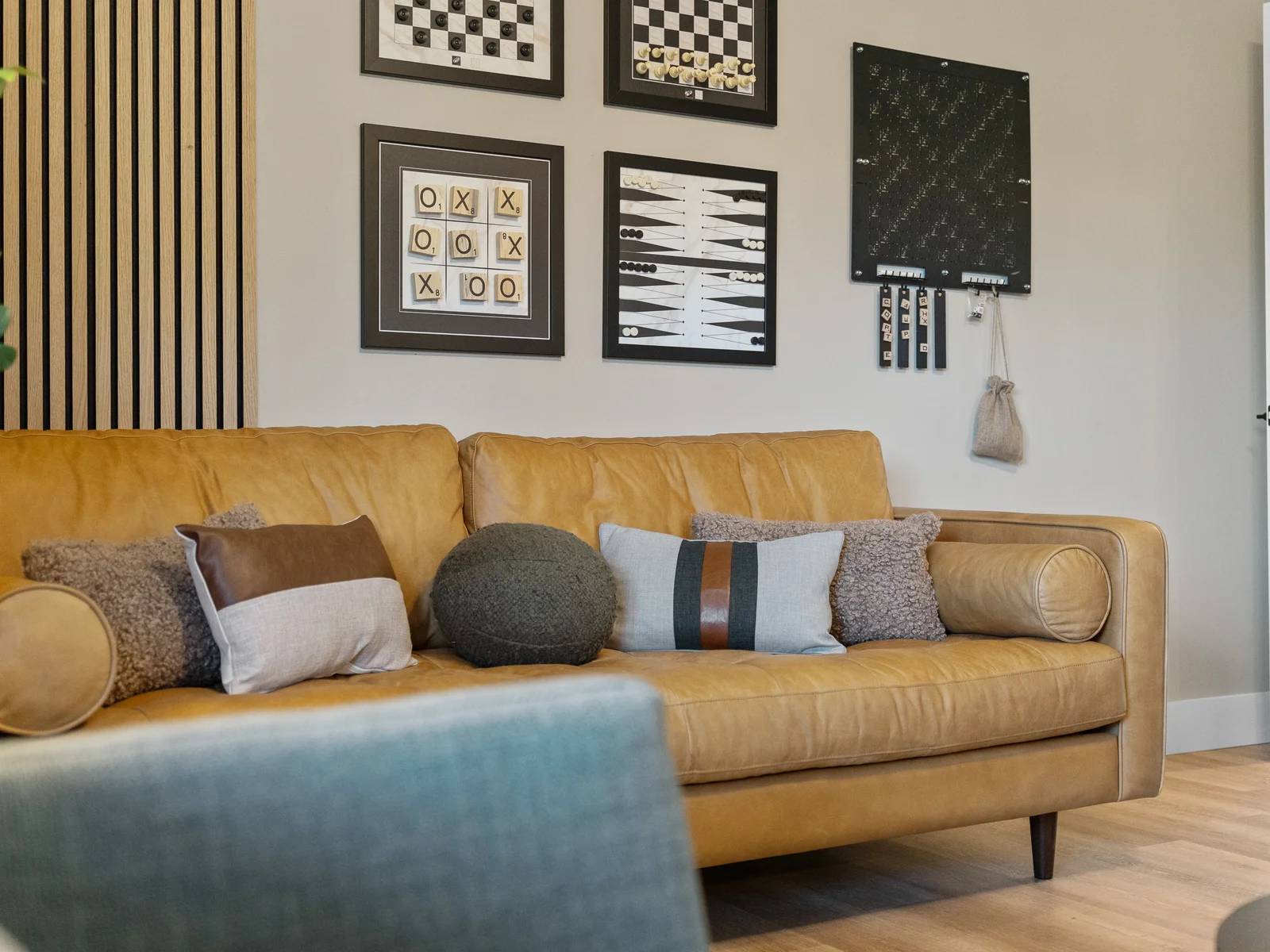 Living Room: Unwind on the stylish leather sofa amid playful game art and warm natural tones!