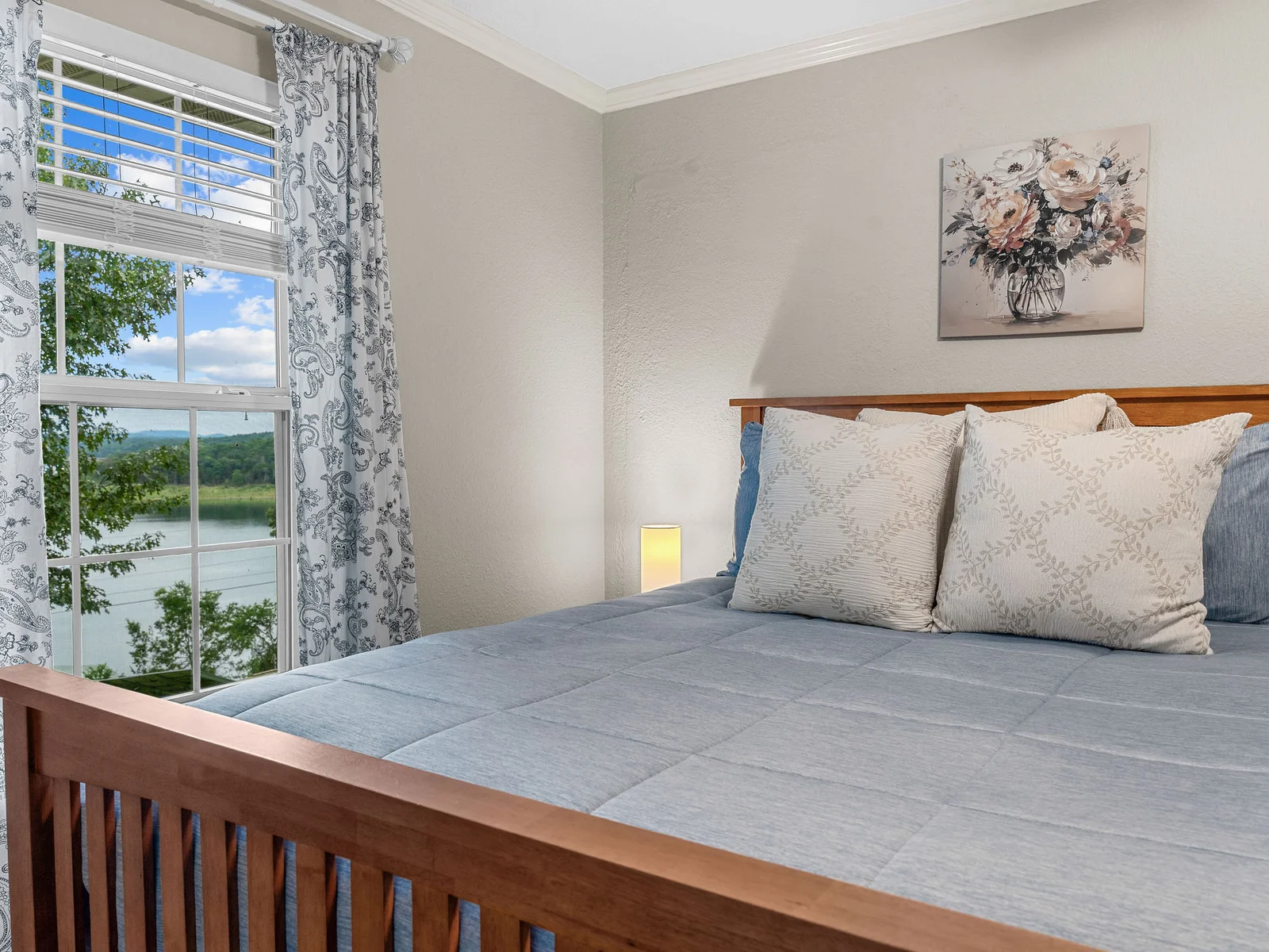 From the bed, you look straight out at the lake — a framed slice of Bull Shoals visible through the window just beyond the footboard. Worth waking up early for.