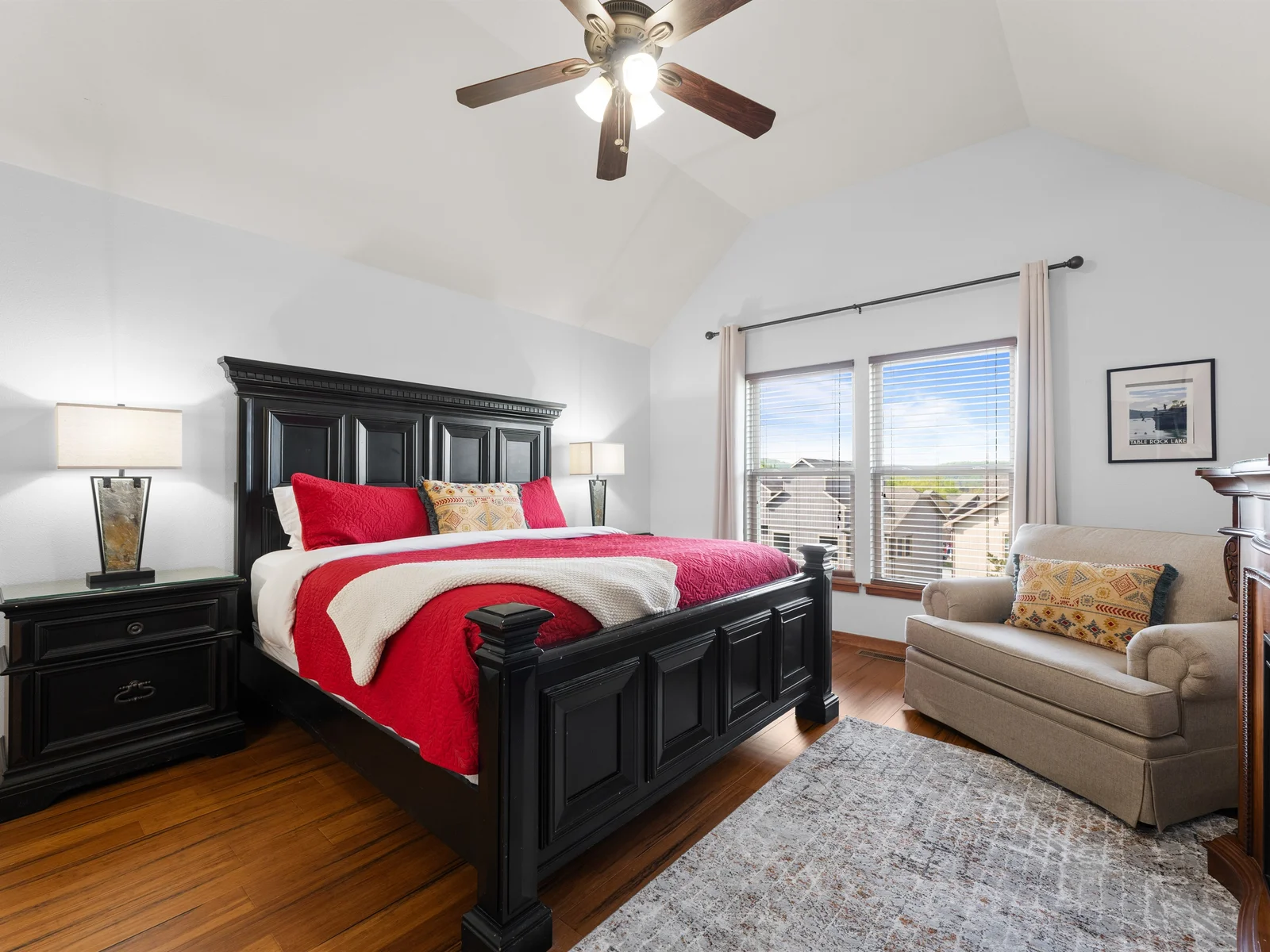 Luxurious bedroom with sturdy furniture, an electric fireplace, TV and ensuite bathroom.