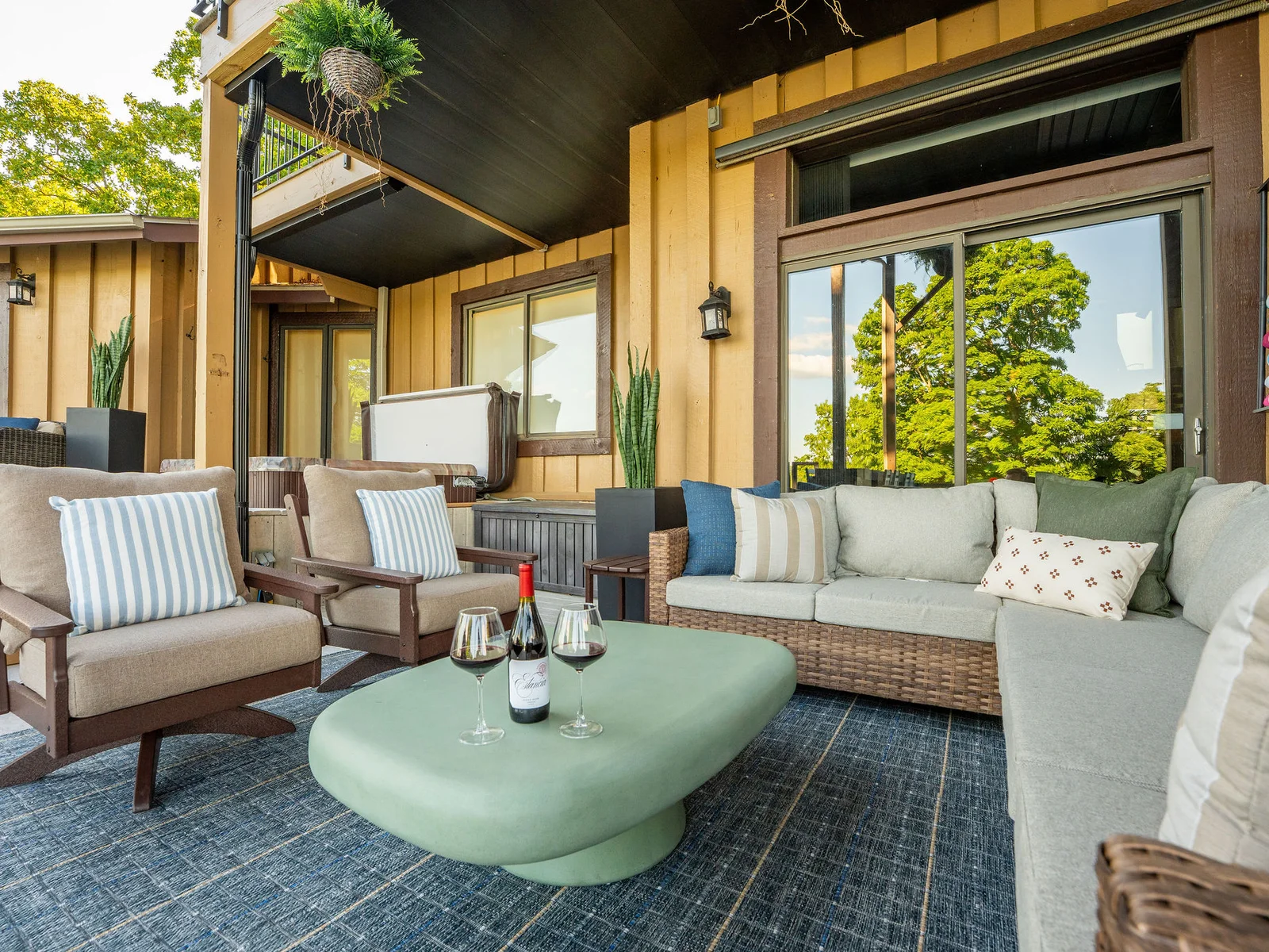 Relax in the covered outdoor lounge where comfortable seating and lake views create the perfect gathering spot.