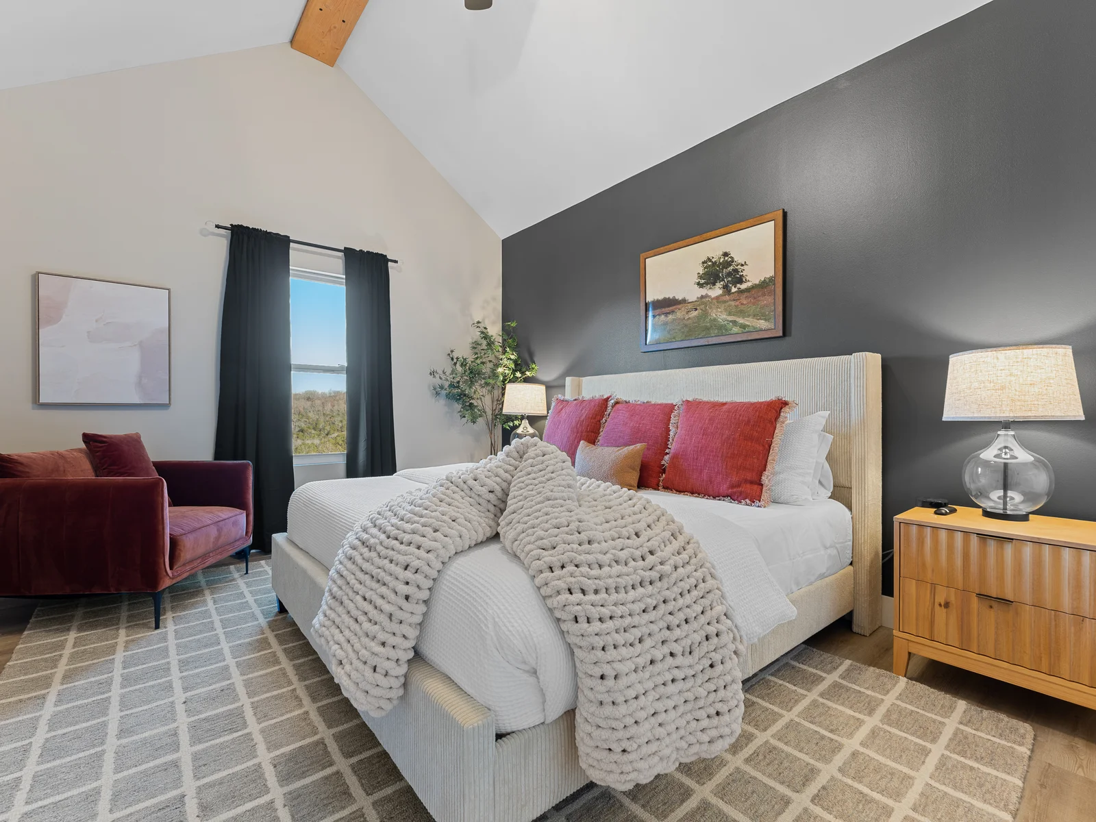 Bedroom Retreat: Stylish decor with striking views, plush king bed, and inviting armchair await you!
