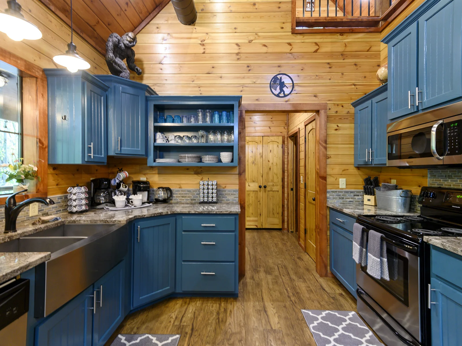 This well-appointed cabin kitchen blends rustic charm with modern comforts, creating a warm and inviting space for both cooking and gathering. Nature's beauty outside, culinary delights inside – the perfect recipe for a cozy retreat