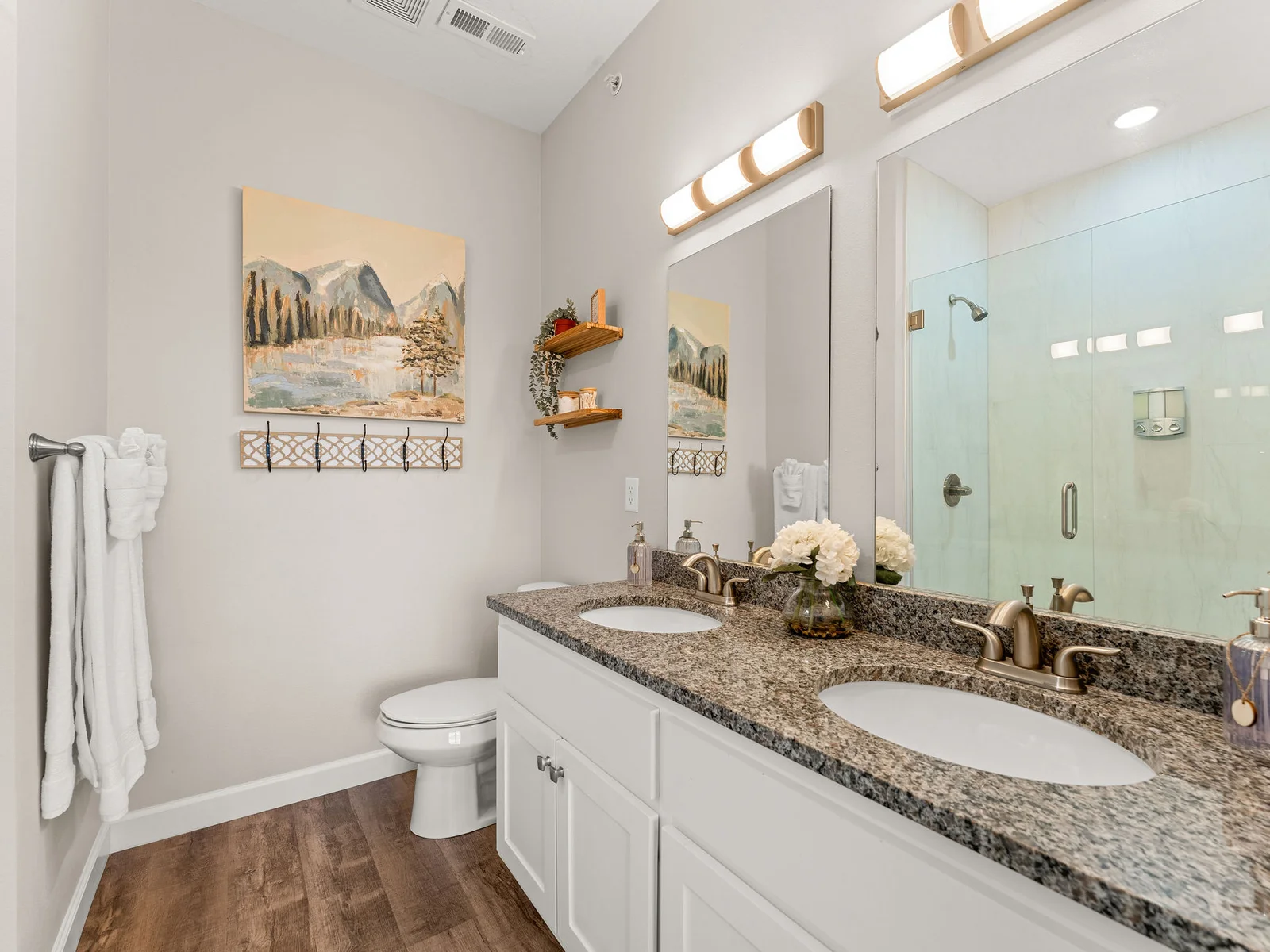 Start your mornings at the double vanity in the primary bath — granite counters, two sinks side by side, no waiting. When there are 12 of you, the second sink matters more than you think.