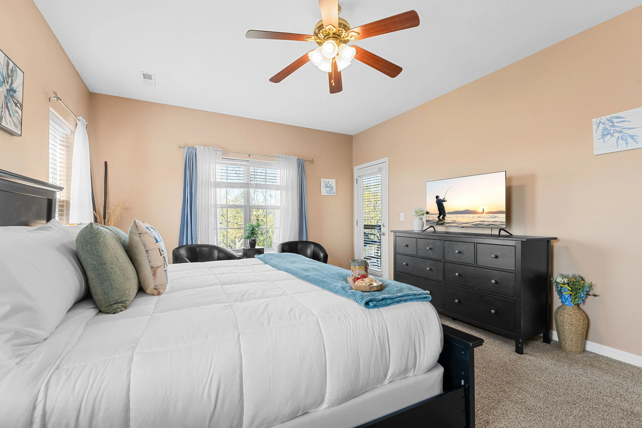 Spacious primary bedroom with king bed, large dresser, smart tv and walk out access to the deck.