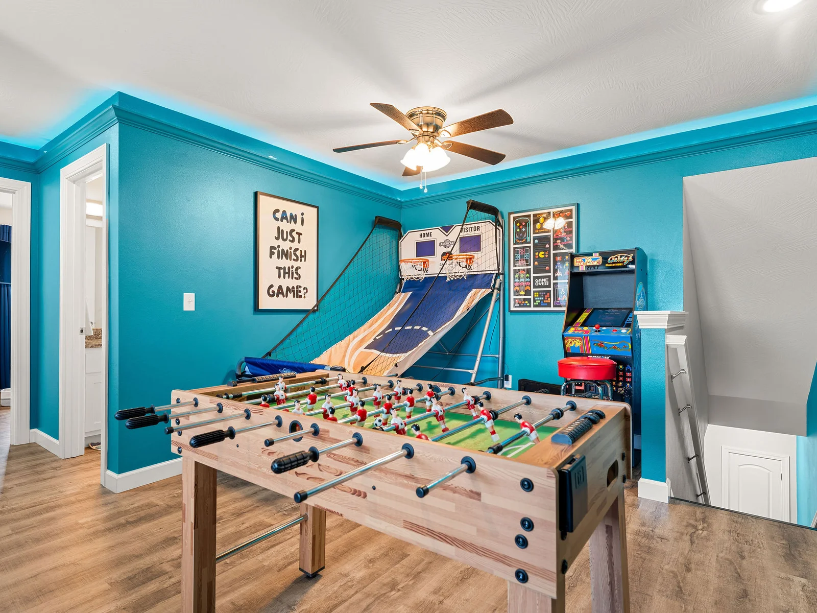 Claim your machine before the kids do — arcade cabinets, foosball, basketball shootout, all waiting on the second floor. Fair warning: the adults fight over time in this room just as much as the kids.