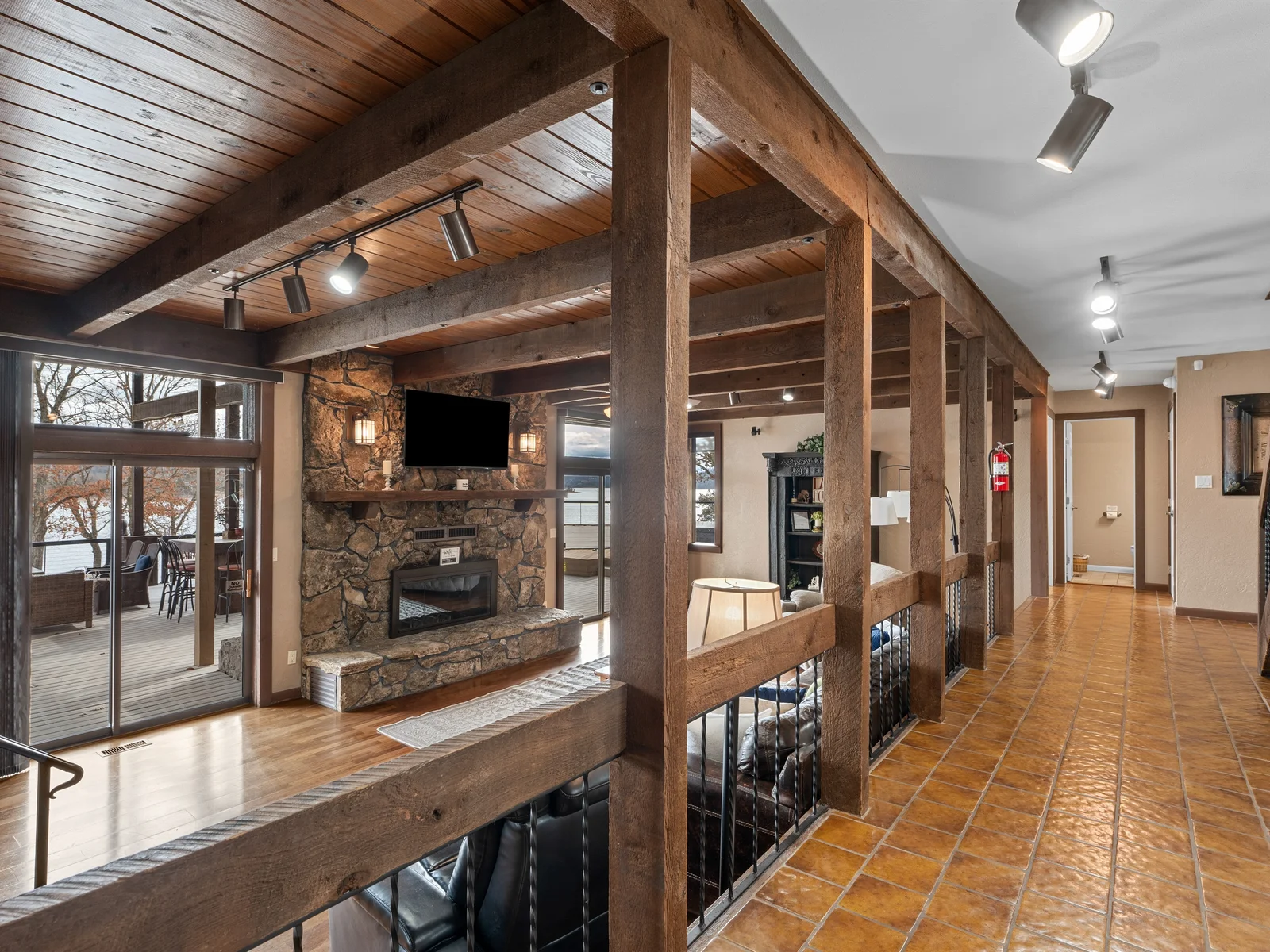 Open-concept design with warm wood tones and lake views creates a relaxed lodge-style atmosphere.