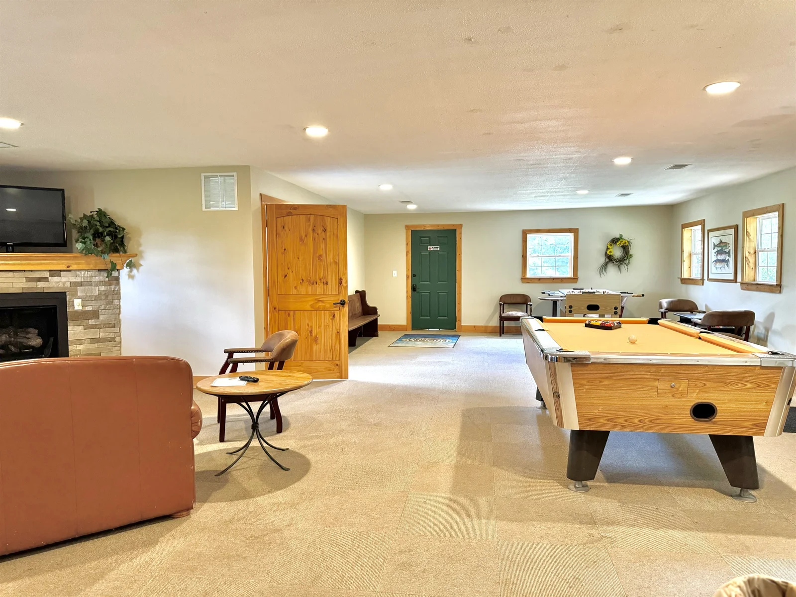 Seating area with TV, electric fireplace and a pool table! Located in the Clubhouse!