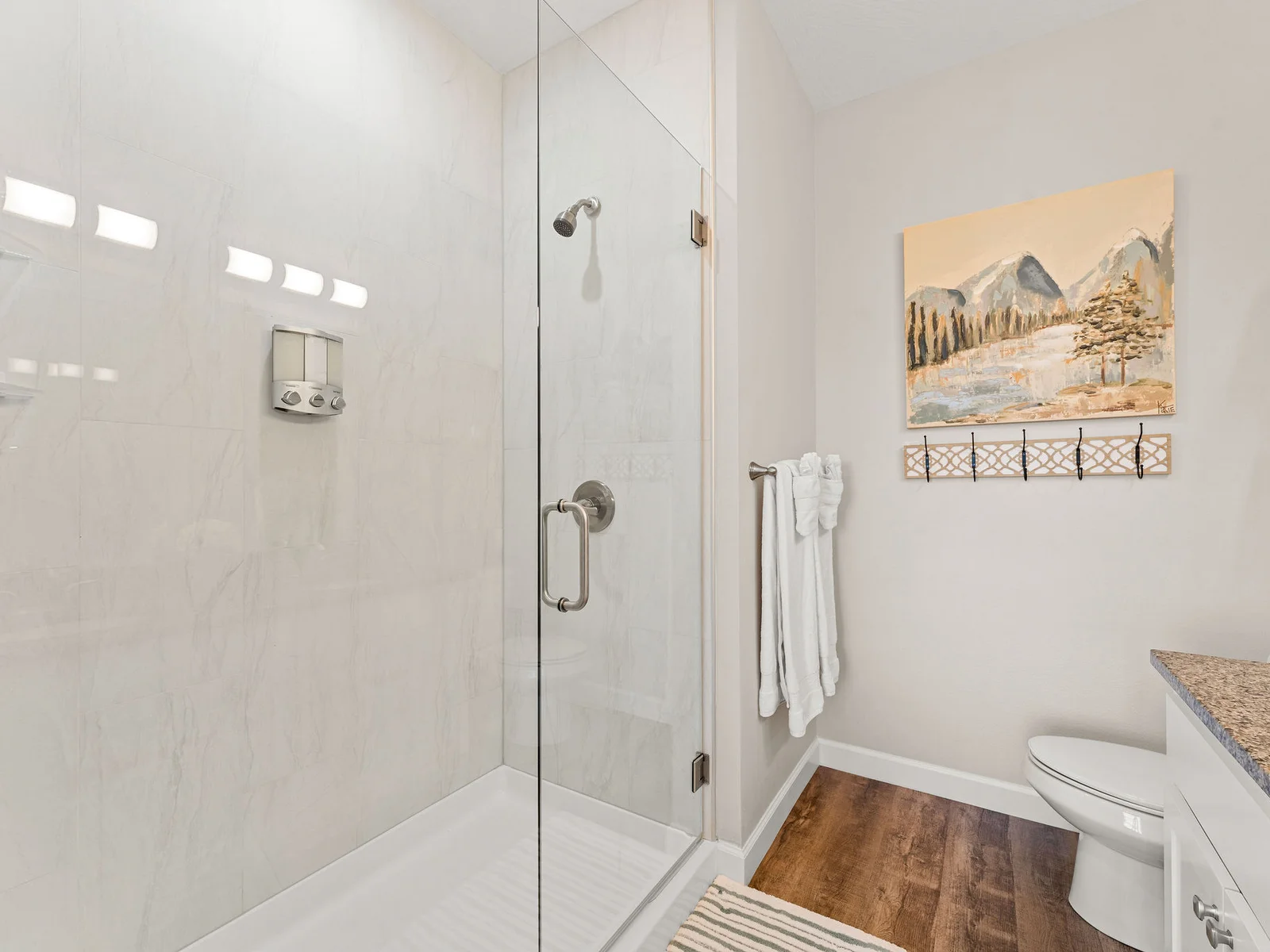 Step into the custom tile walk-in shower — glass door, full pressure, and complimentary toiletries already lined up. Get clean and get back out to the mountains.