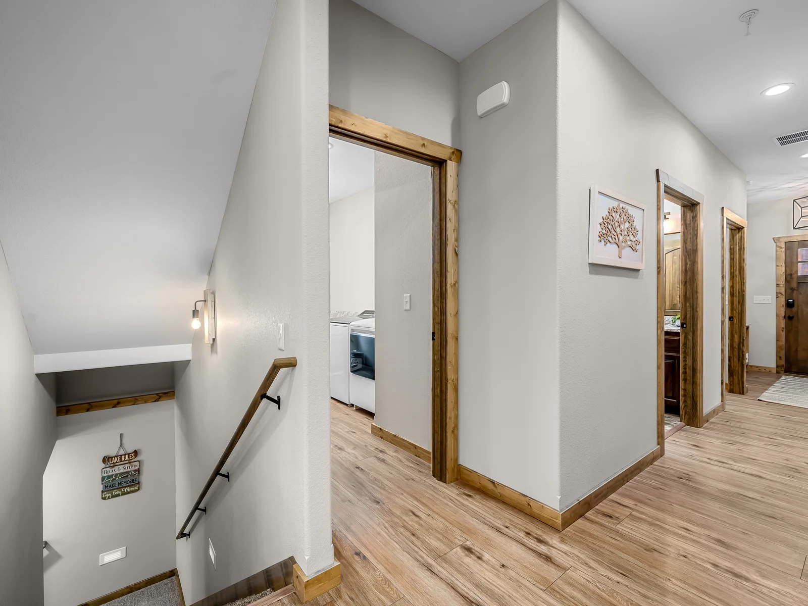 View from front door leading into kitchen with view to laundry room and downstairs