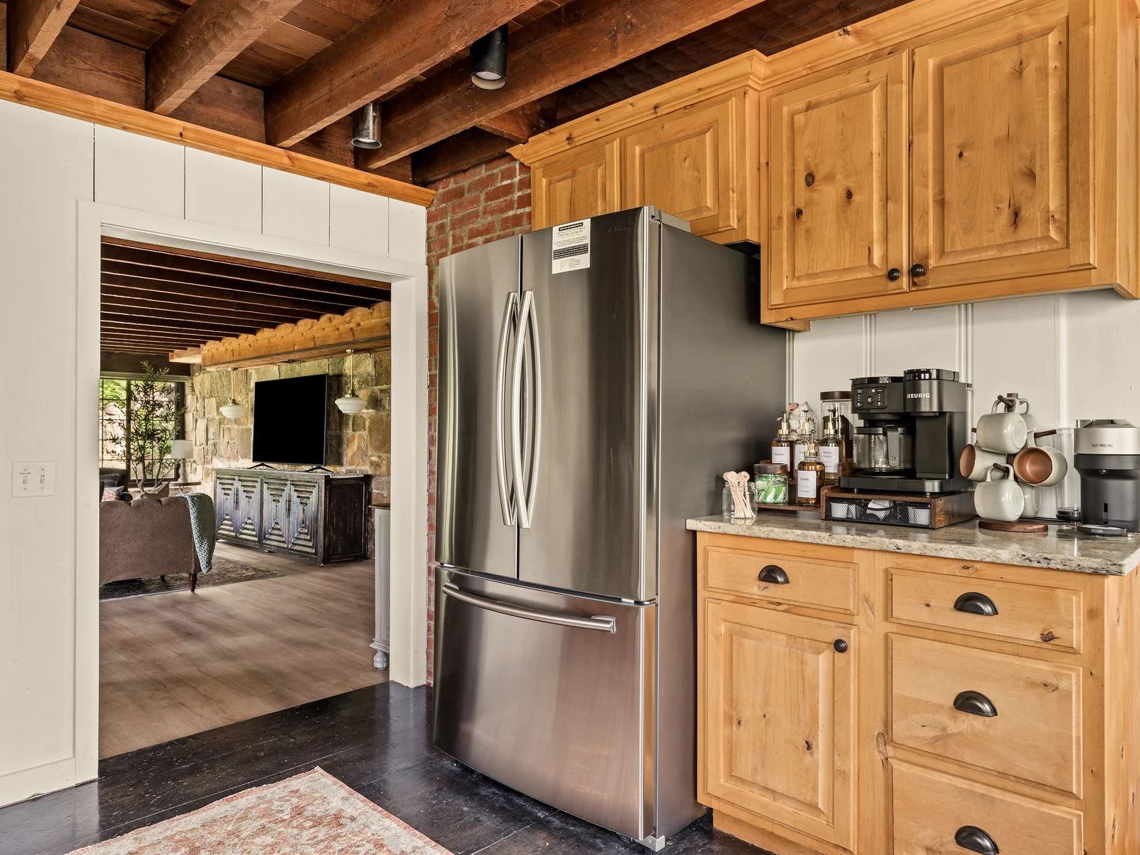 Fully equipped kitchen with stainless appliances and a stocked coffee bar, just steps from the living space.