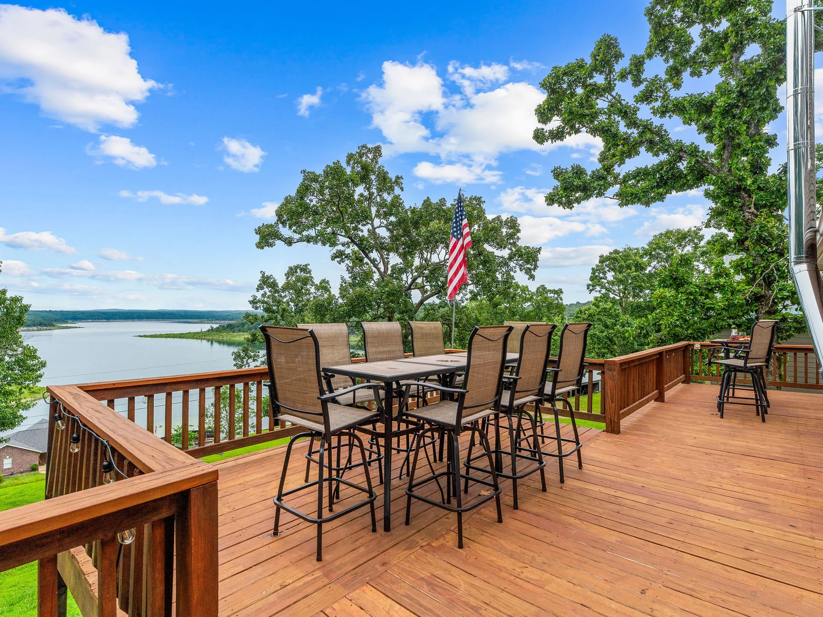 The bar-height dining table on the upper deck fits six, has a direct line to the grill, and looks straight out over Bull Shoals Lake. The American flag does not move an inch.