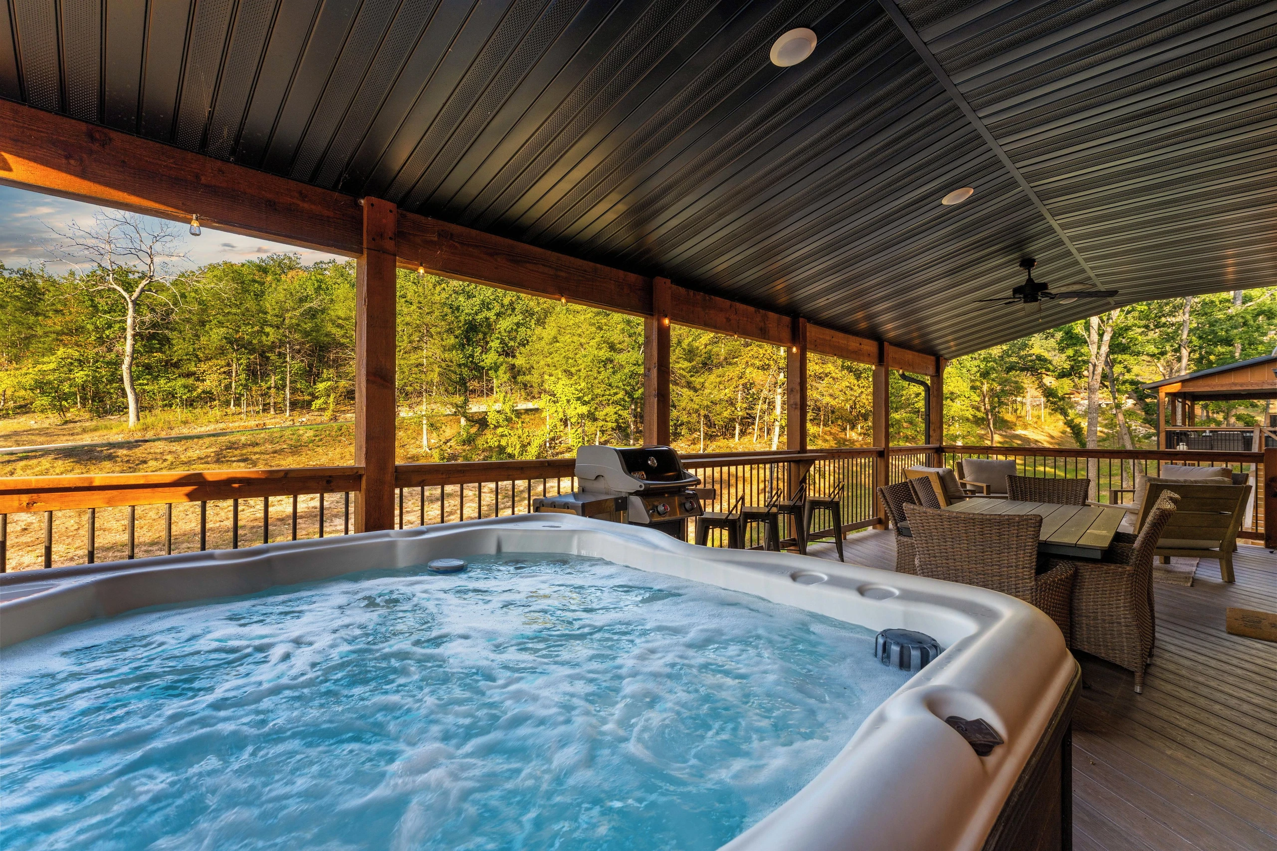 Outdoor spa tub, on large deck, whirlpool seats 6. Dining table and chairs, bar facing out with 4 stools, conversational area with 4 comfortable chairs and coffee table.