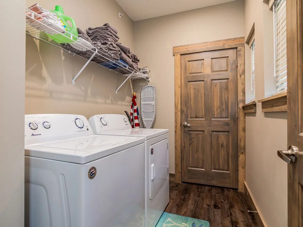 Two sets of full washers and dryers, plus a stacking washer/dryer on upper level