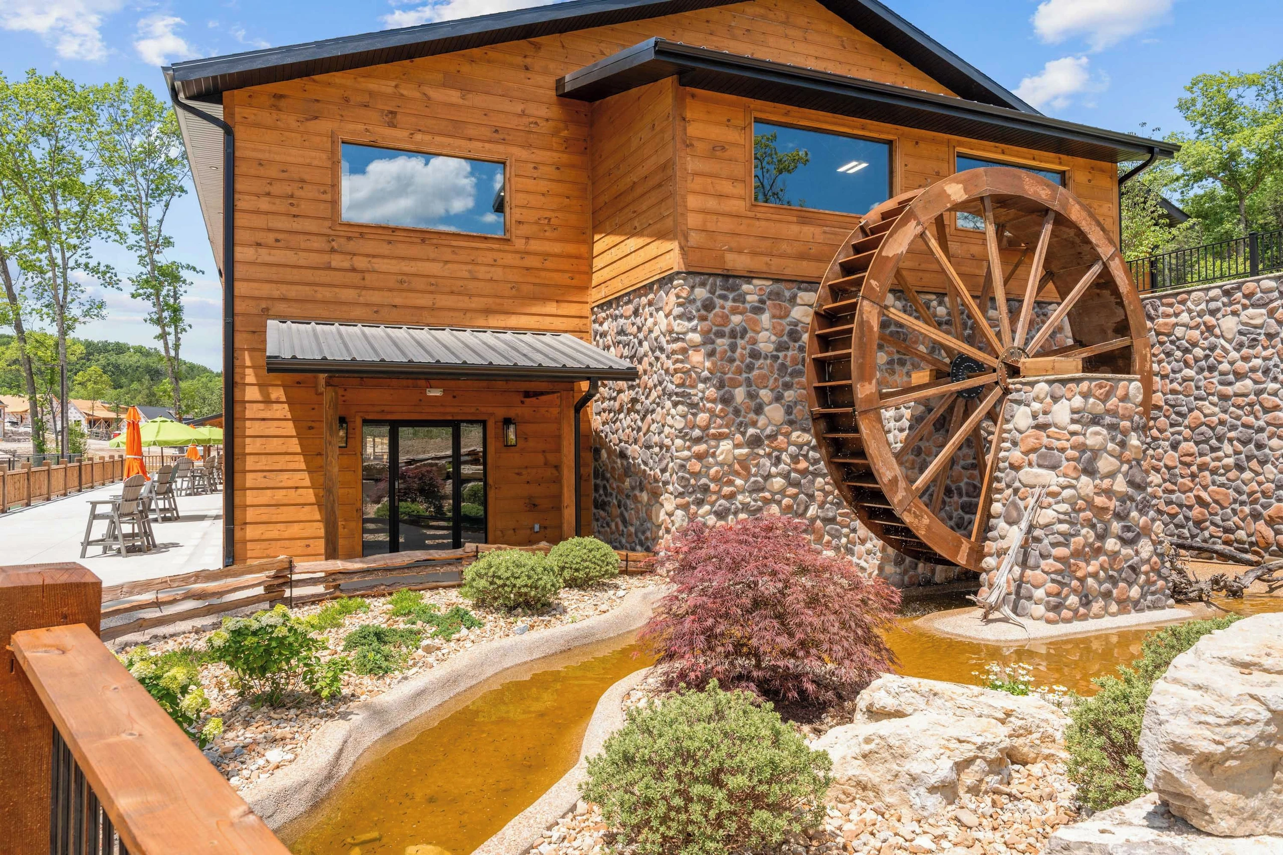 End of indoor pool area. Large water wheel turning is visible from the cabin deck. Sitting area in picture is overlooking the pickleball and basketball courts.