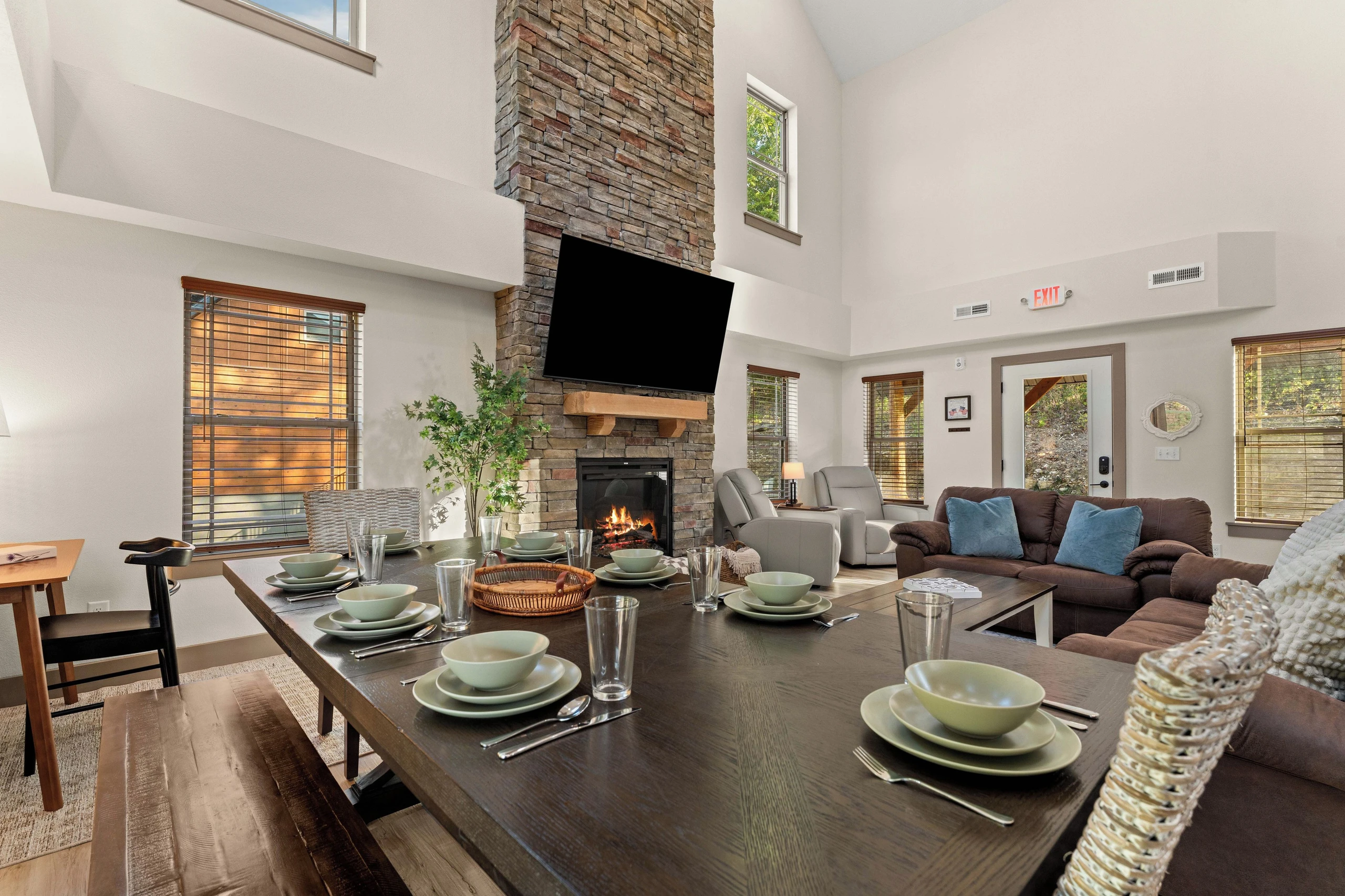 Large dining table with 2 benches and 2 chairs seats about 8. Steps away from sliding glass door with an additional dining table and 8 chairs outside. Indoor counter also seats 4 at barstools for dining.
