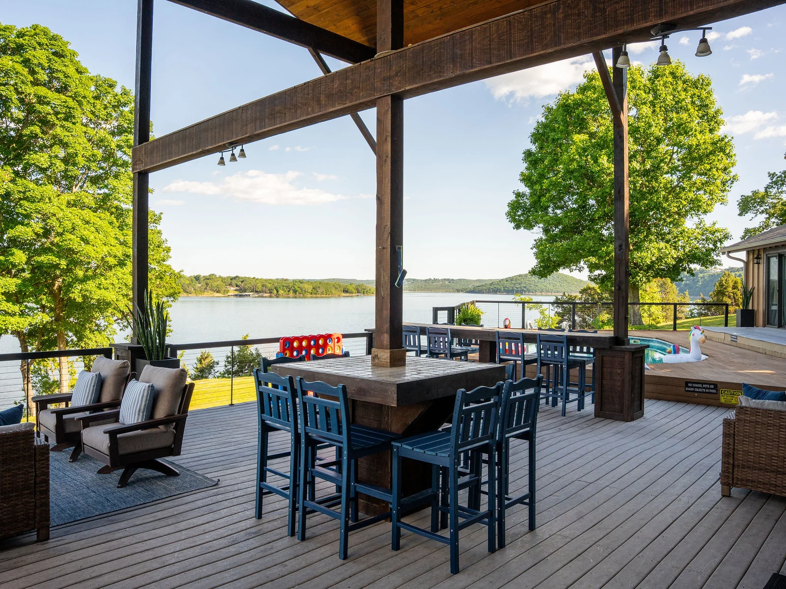 Dine, relax, and enjoy lakefront living from this spacious covered deck designed for all-day enjoyment.